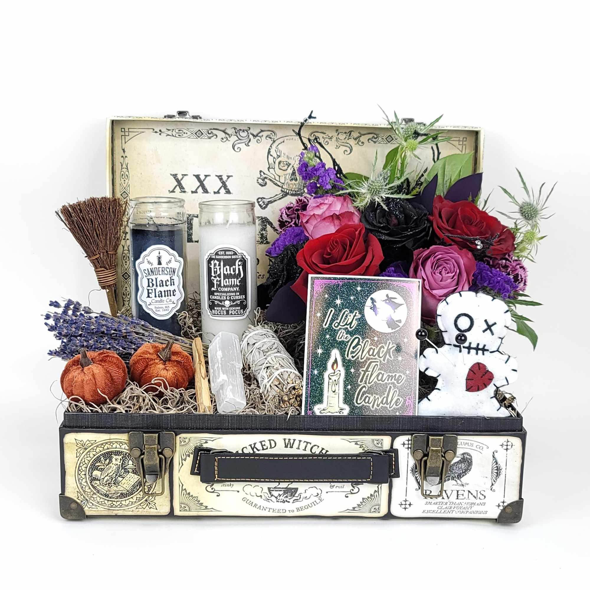 A beautiful box with a small arrangement, candles, and a small sage A beautiful box with a small arrangement, candles, and a small sage