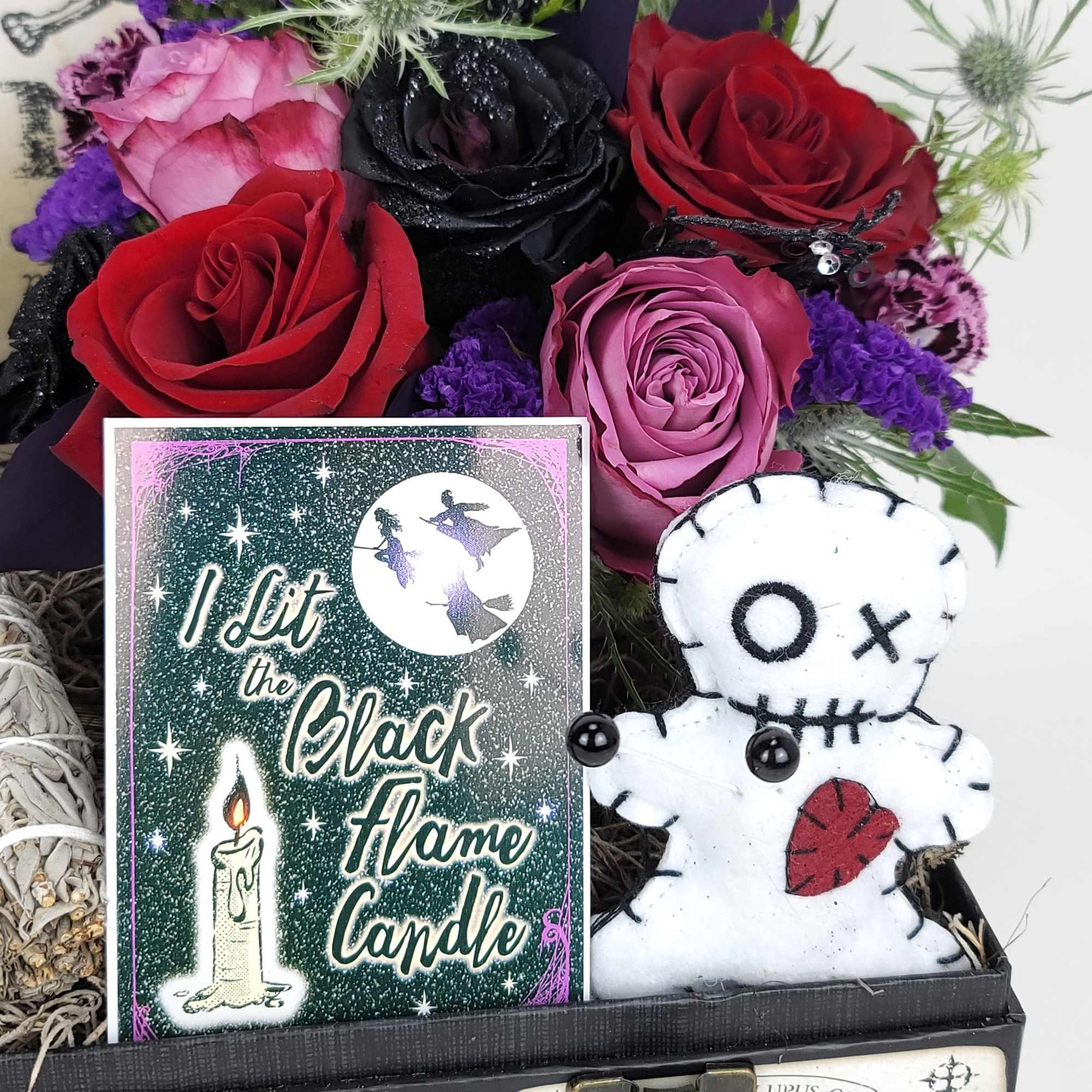 A beautiful box with a small arrangement, candles, and a small sage A beautiful box with a small arrangement, candles, and a small sage