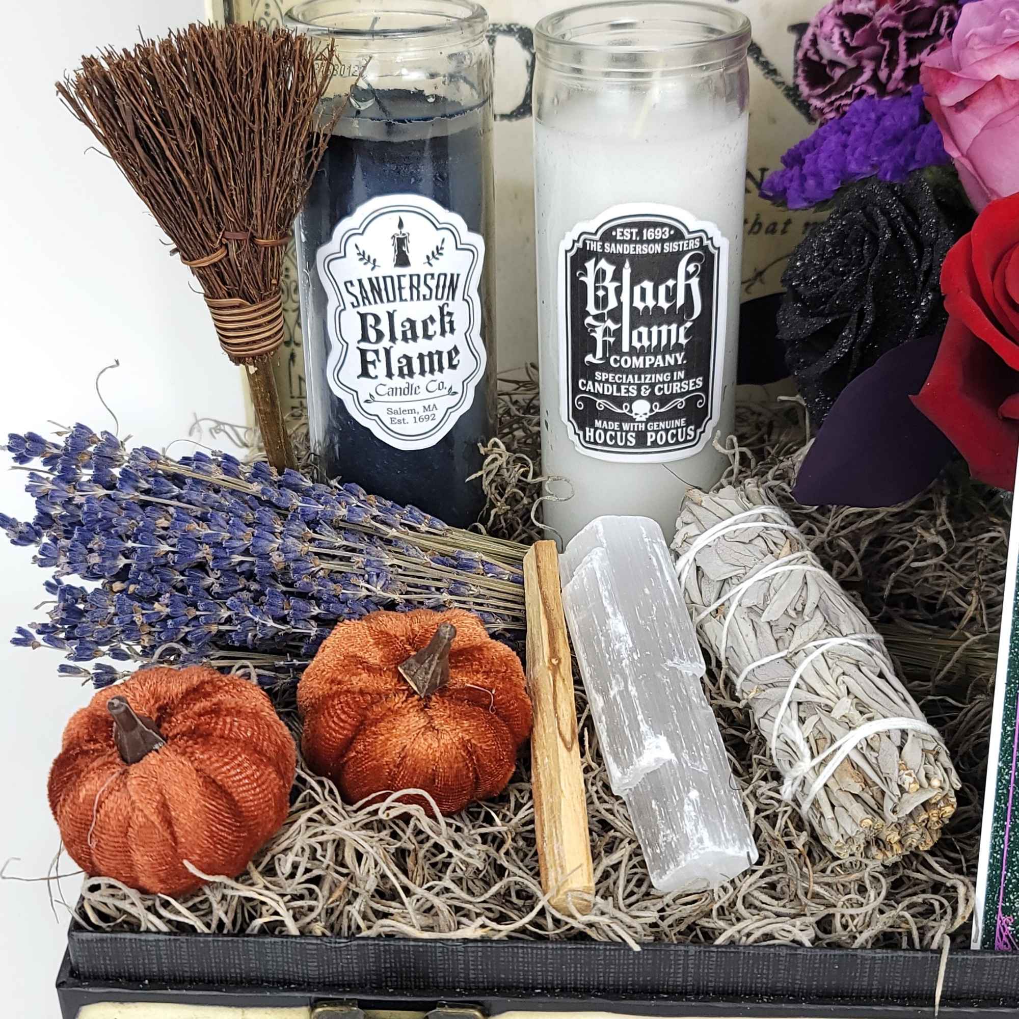 A beautiful box with a small arrangement, candles, and a small sage A beautiful box with a small arrangement, candles, and a small sage