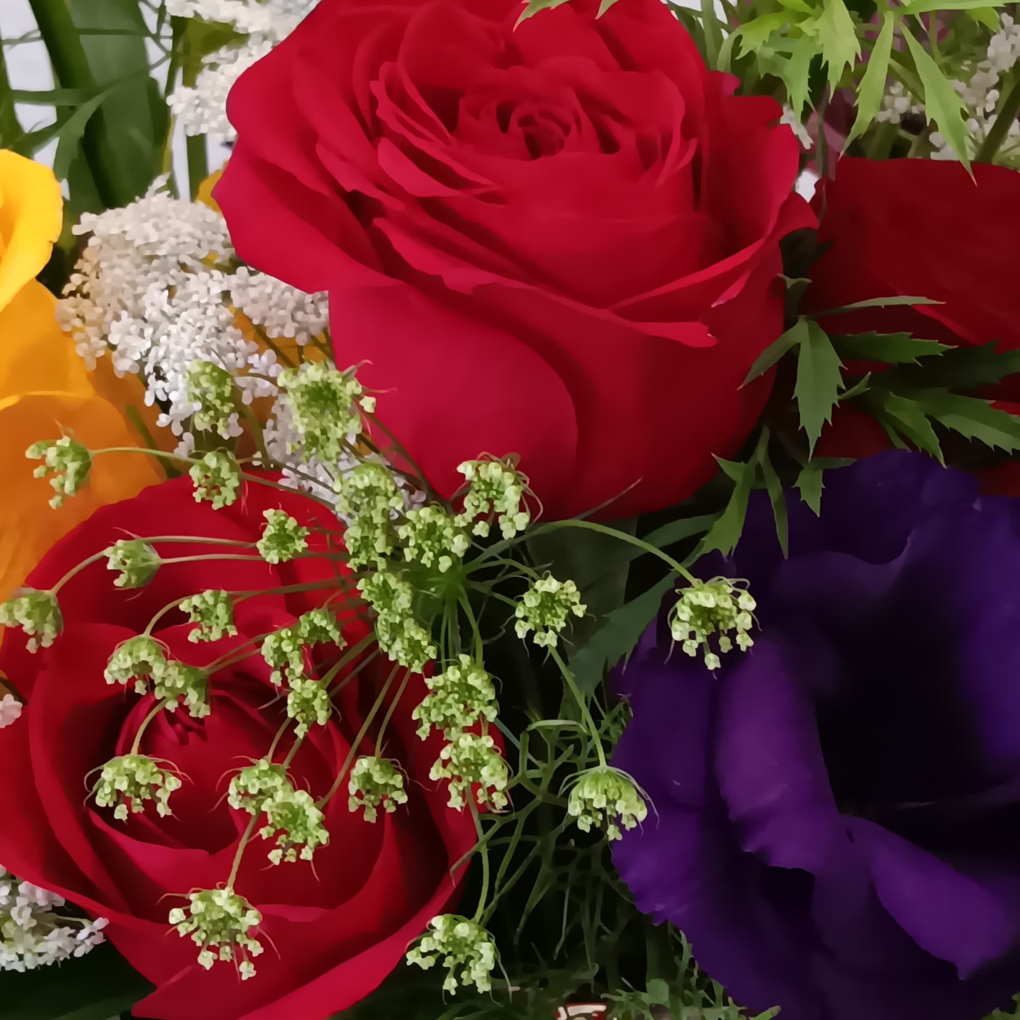 A sunny yellow freesia and yellow roses bouquet gets an autumnal spin