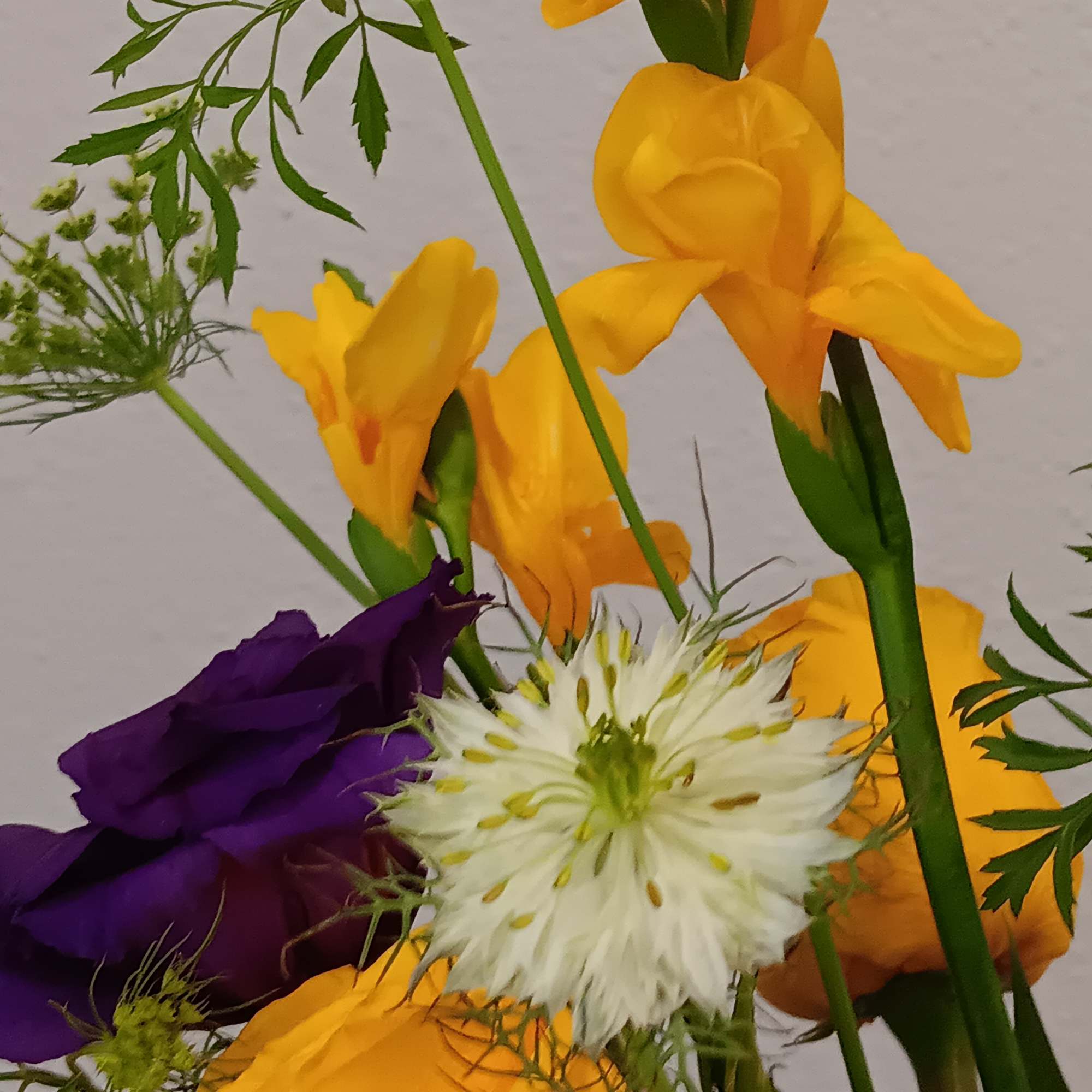 A sunny yellow freesia and yellow roses bouquet gets an autumnal spin