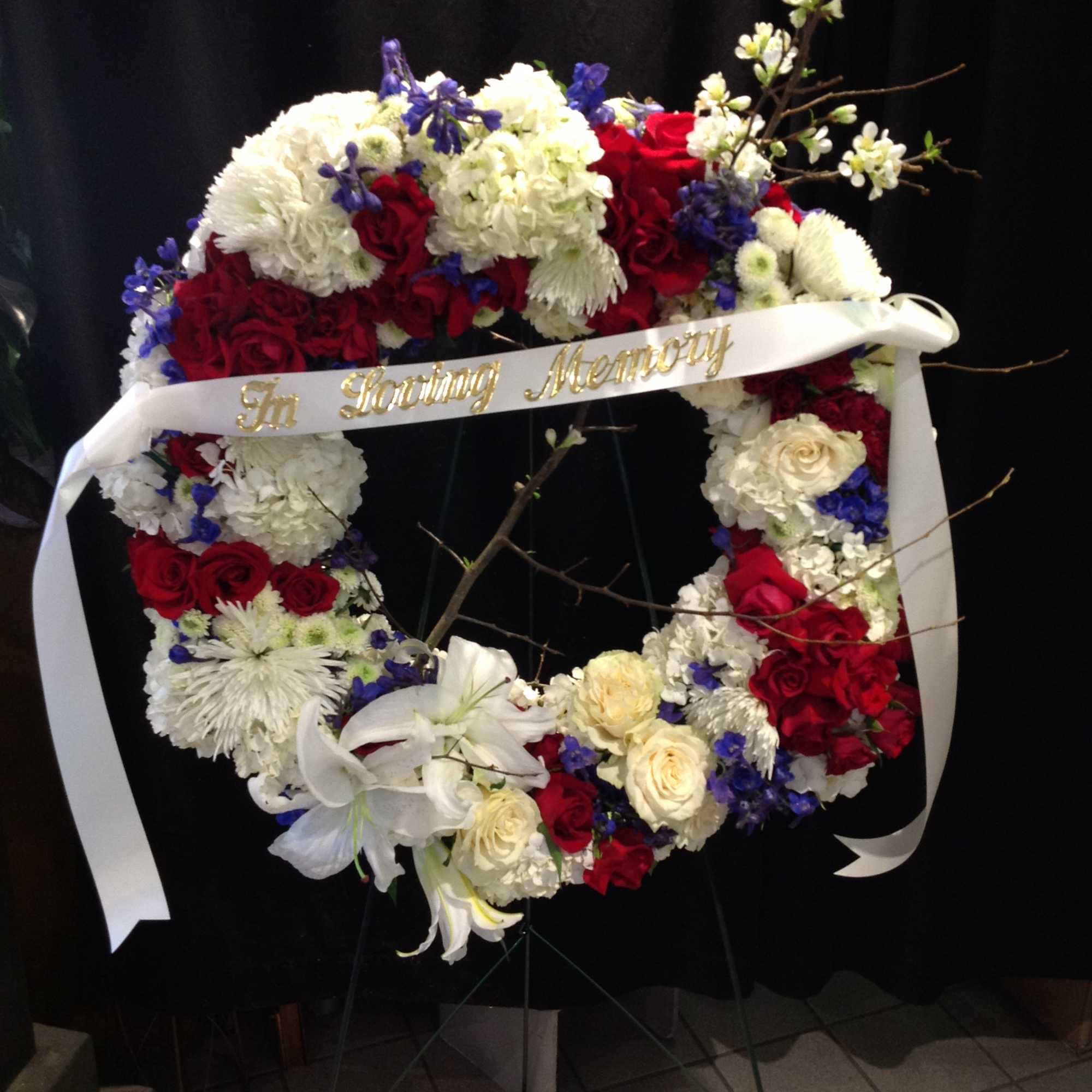 Patriotic red, white and blue wreath standing spray 
*Pricing does not include Patriotic red, white and blue wreath standing spray 
*Pricing does not include