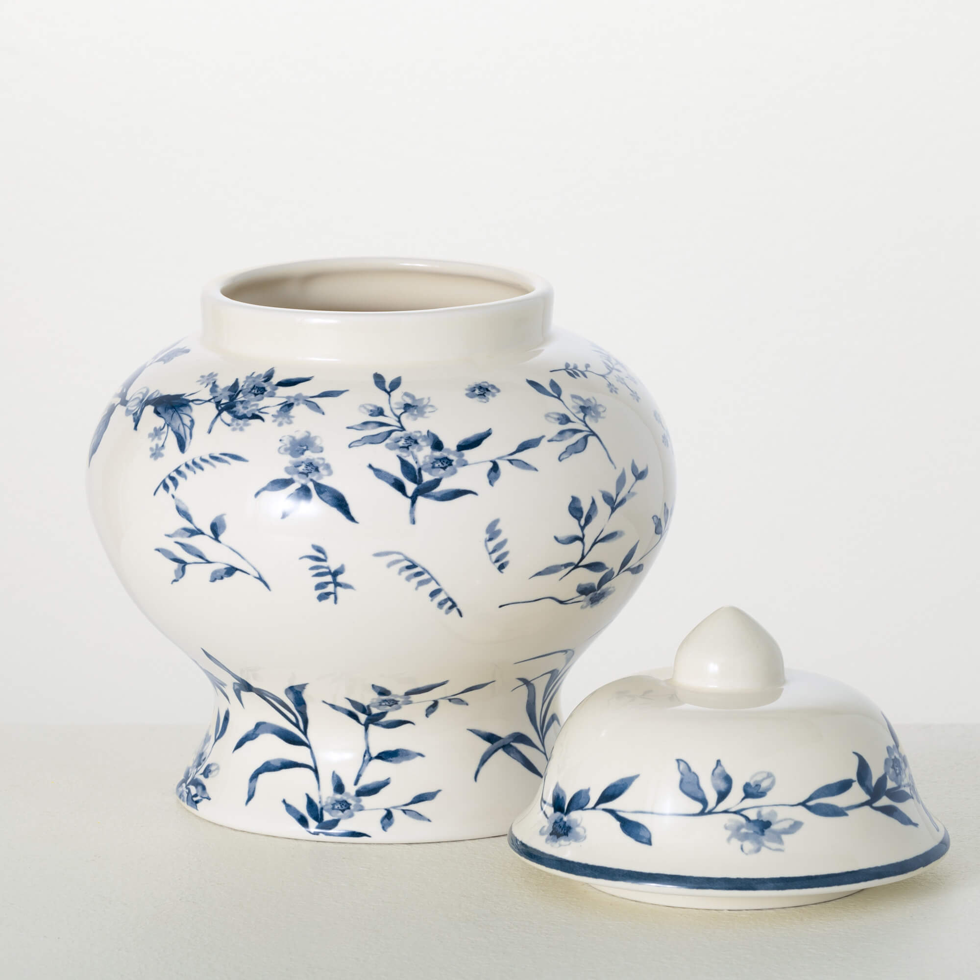 This ginger jar features blue floral artwork on a stylish ceramic jar.