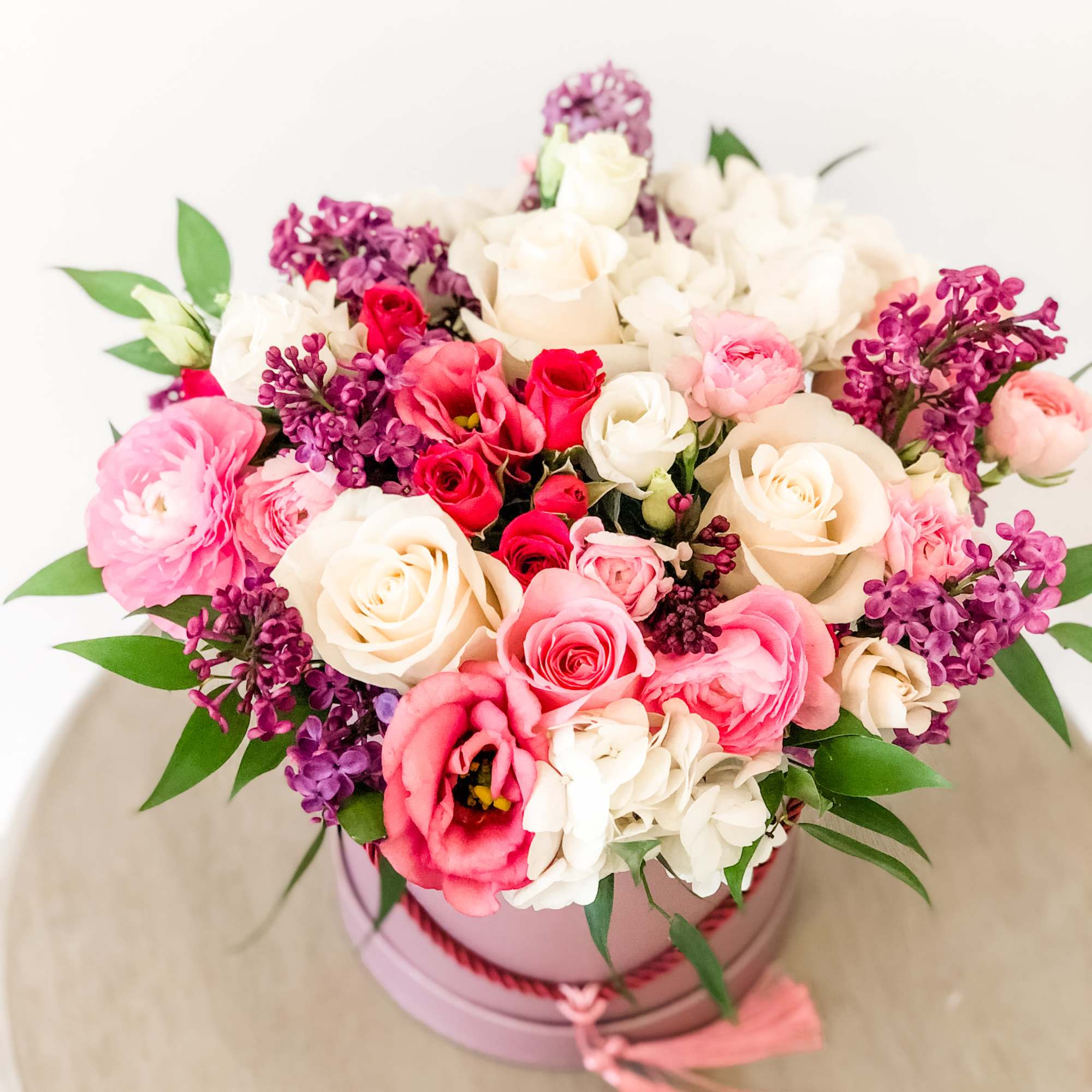 A pleasing combination of beautiful arrangement of Lilac, , ranunculus, pink roses