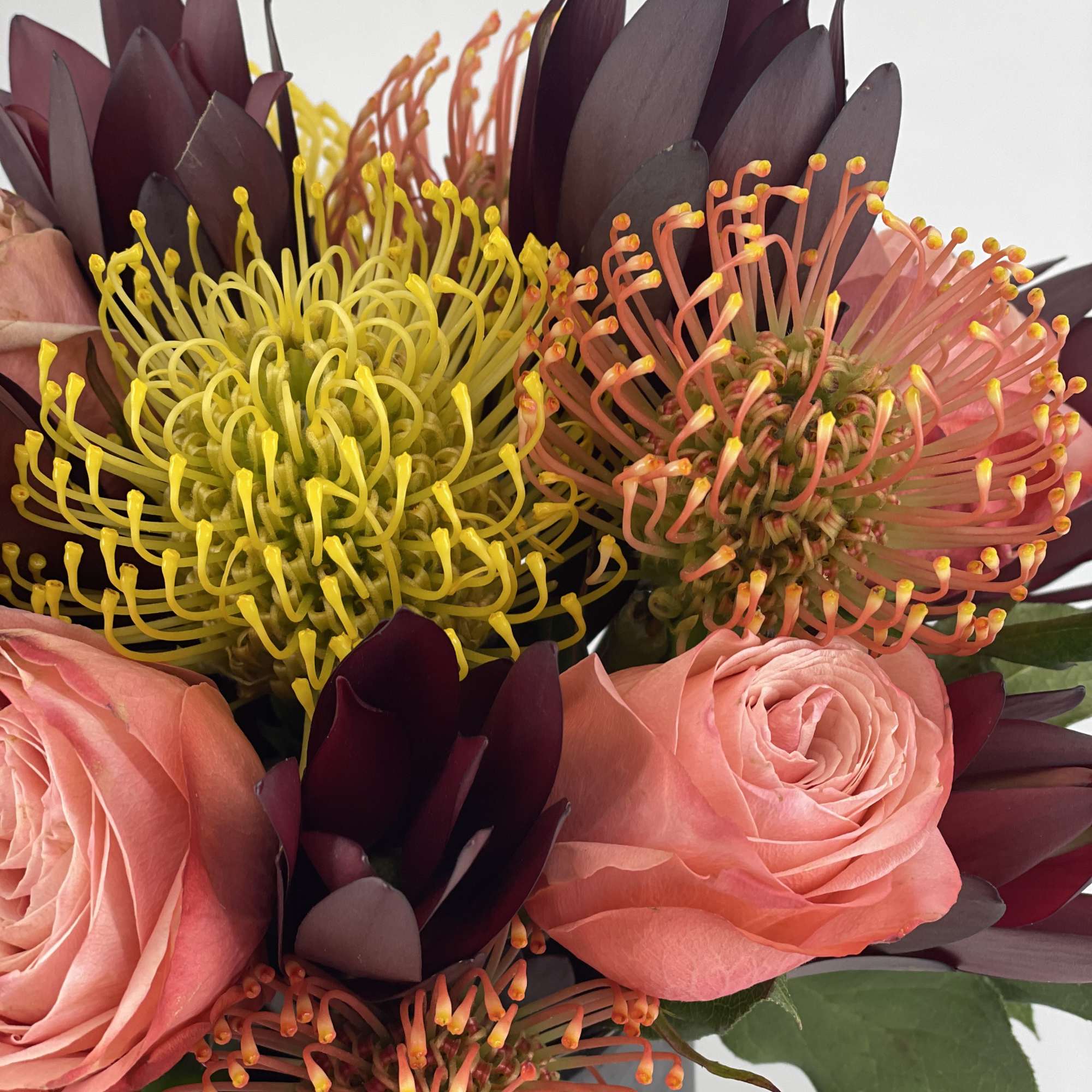 The focal points of this unique arrangement are the varieties of Protea.