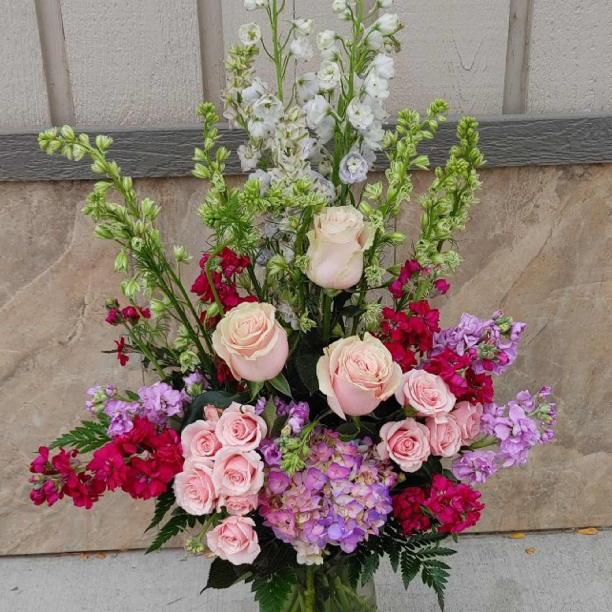 Elegant beauty stems from within this lovely arrangement of larkspur, snapdragons and Elegant beauty stems from within this lovely arrangement of larkspur, snapdragons and