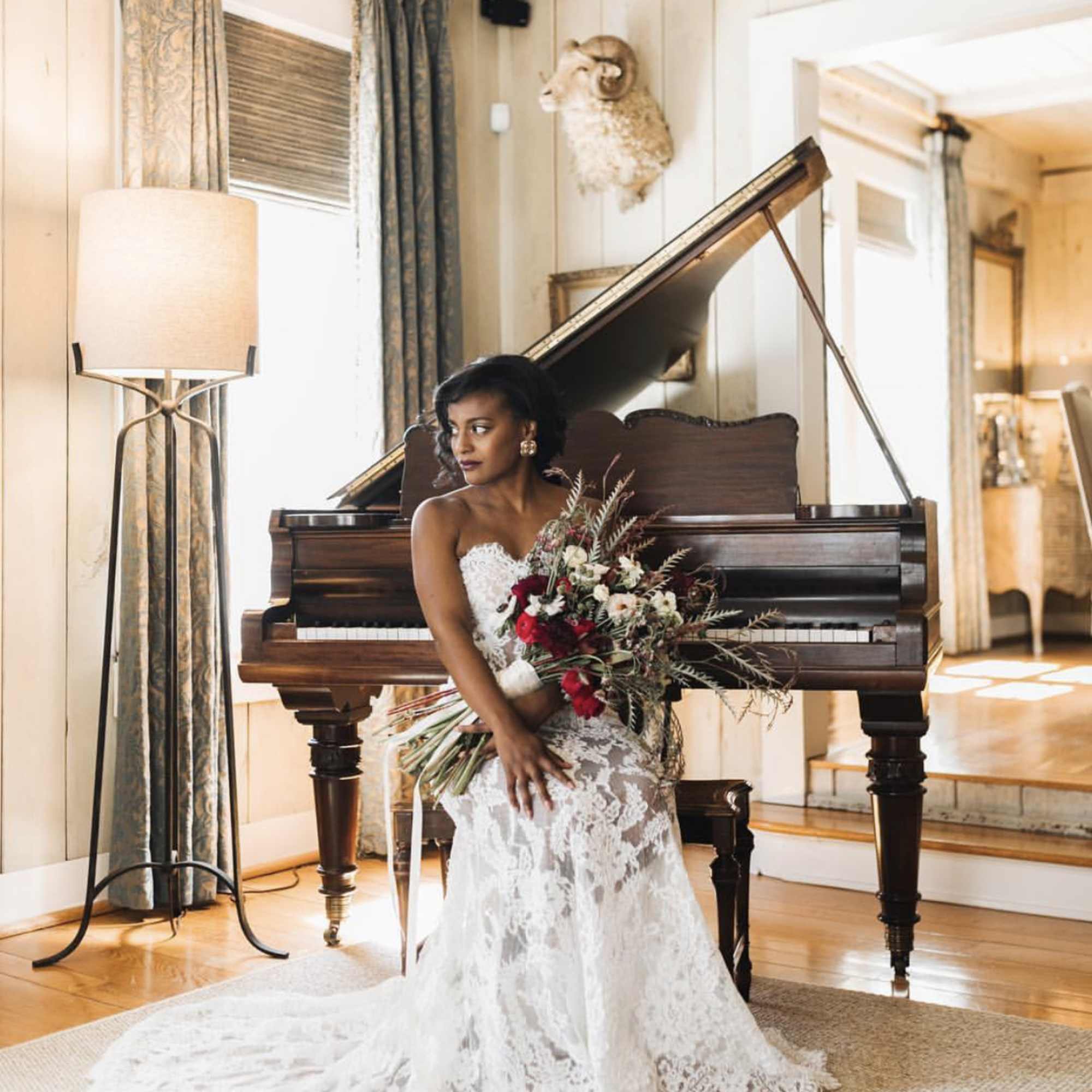 This wild and romantic bouquet of red shades and bold foliage is