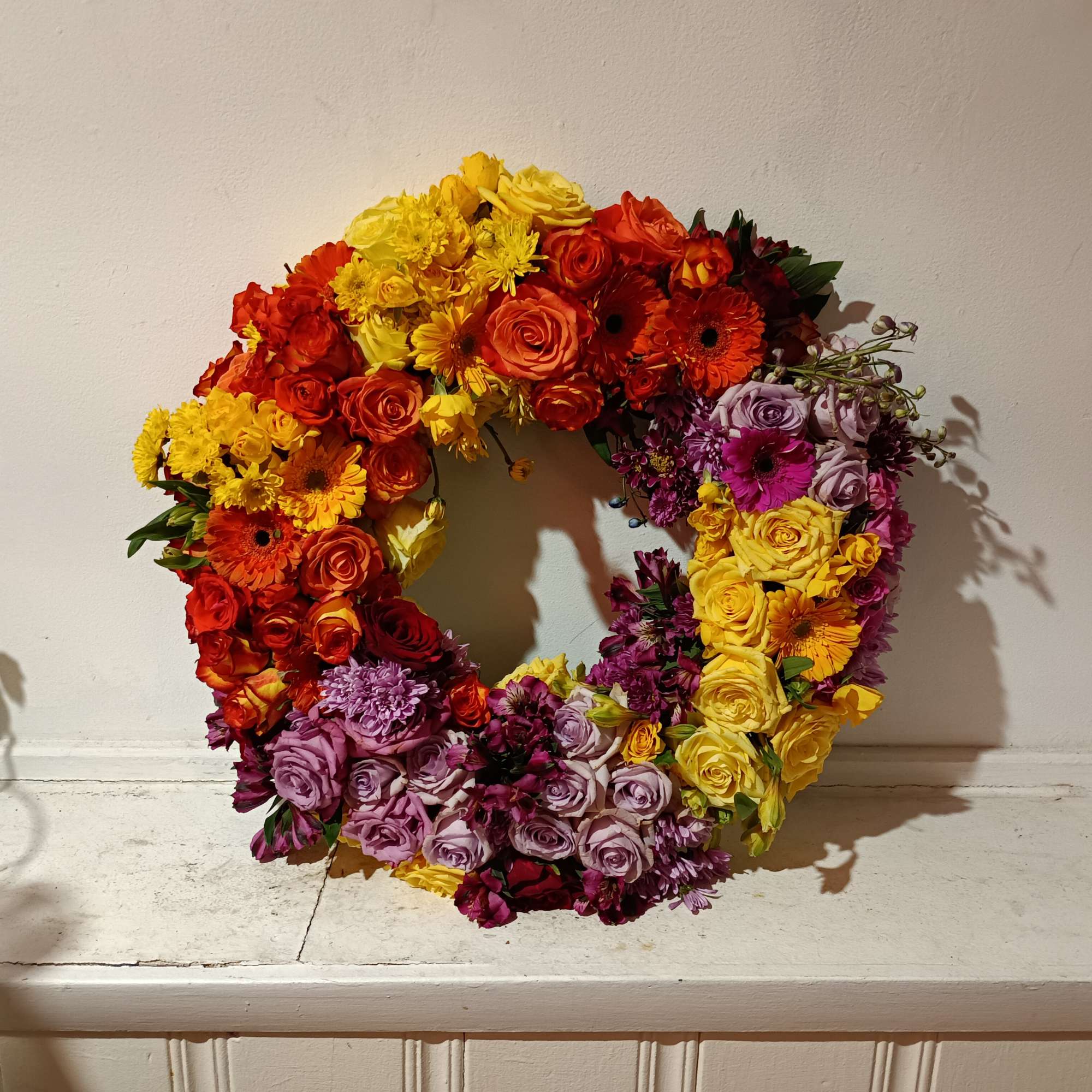 Beautiful bright colors of yellow, orange, burgundy and purple with roses, gerbera