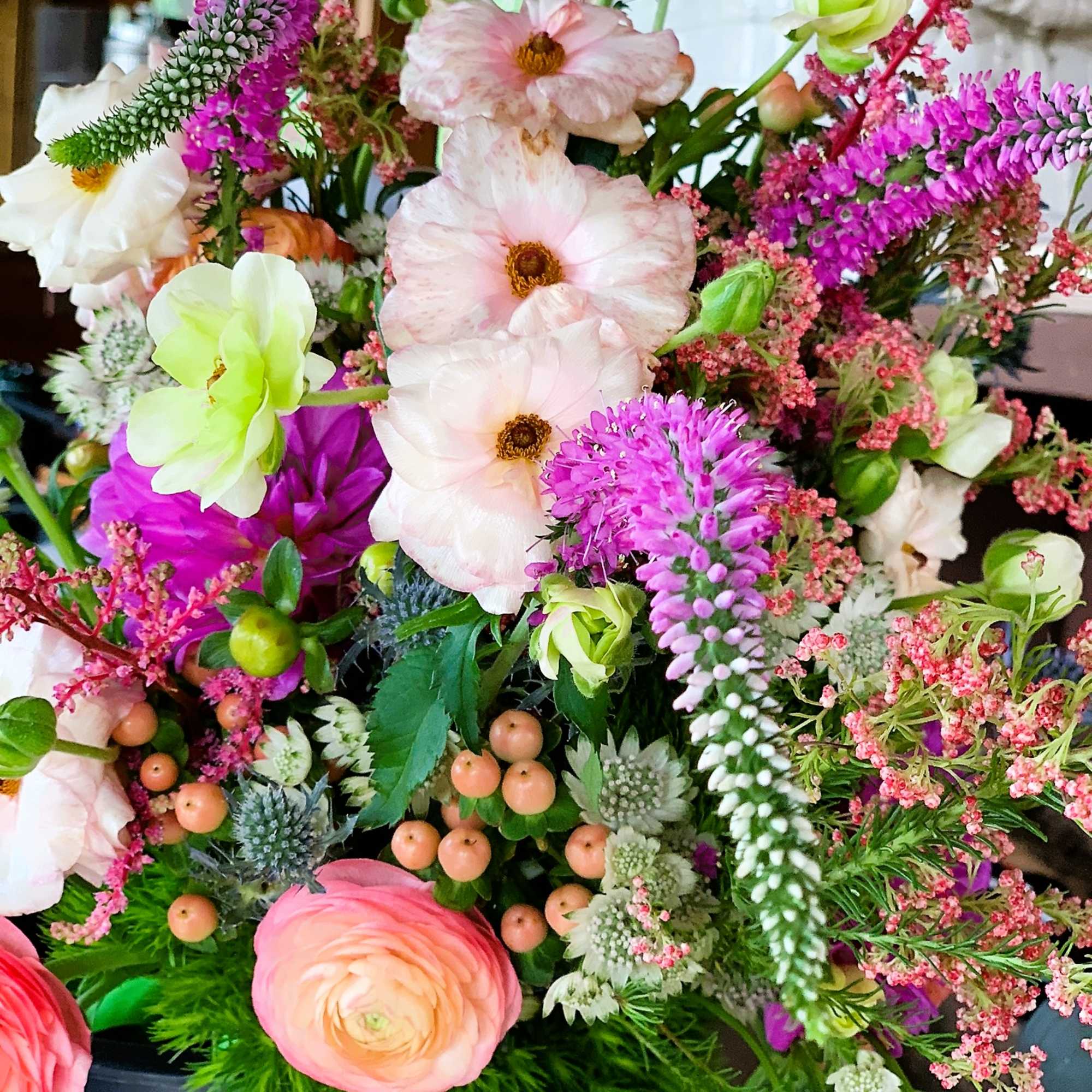 This sweet compact bouquet is bursting with all the bright colors of