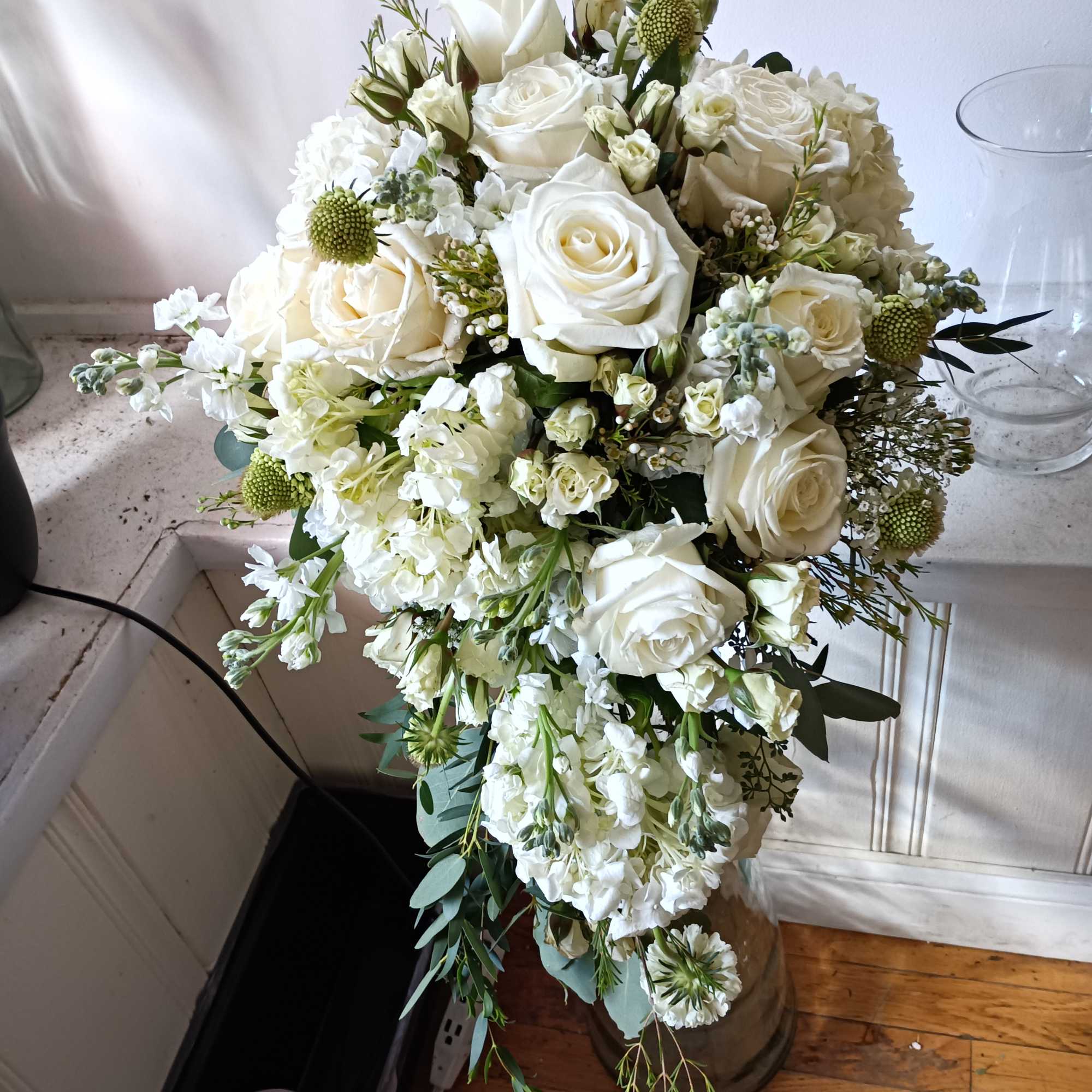 beautiful white roses, stuck and other white fillers with greens