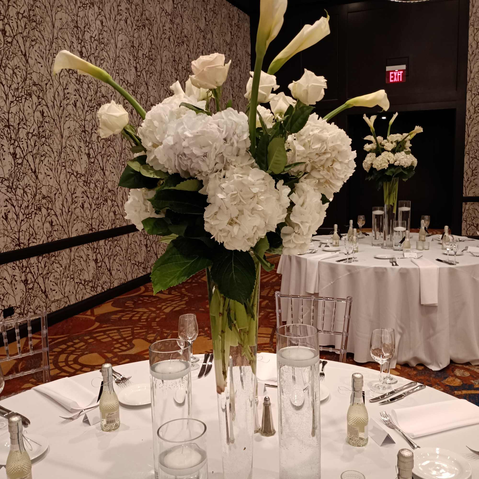 Beautiful white calla lilies, white hydrangea and roses in 24" tall trumpet