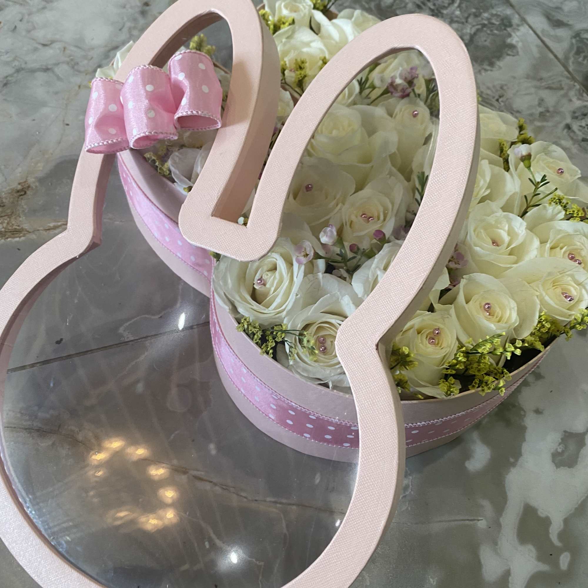 over 24 premium white roses , solidago, and wax flower, in a