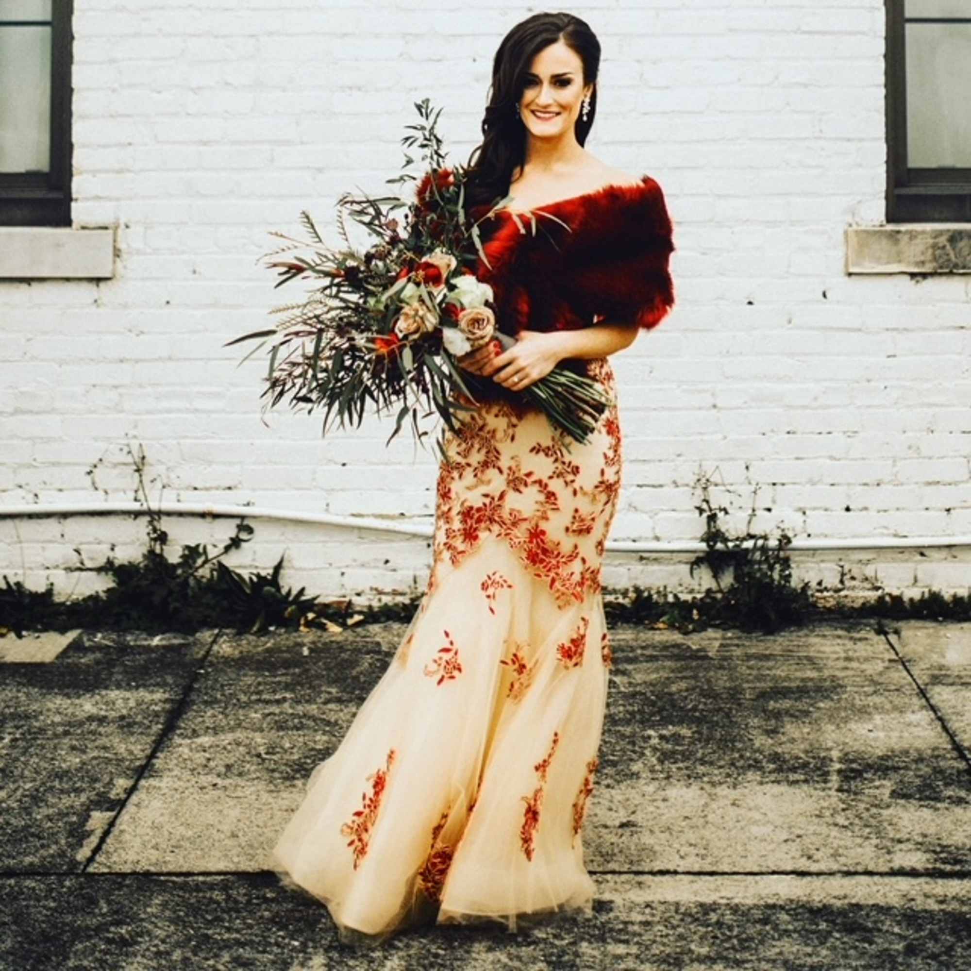 This striking bouquet is filled with drama and color. The deeply romantic