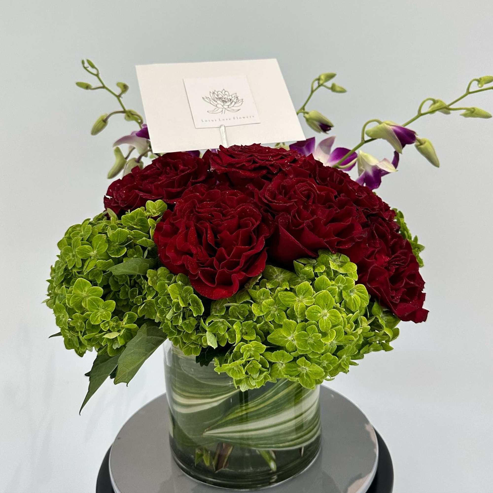 A celebration of luxury and life, this large and jewel toned arrangement