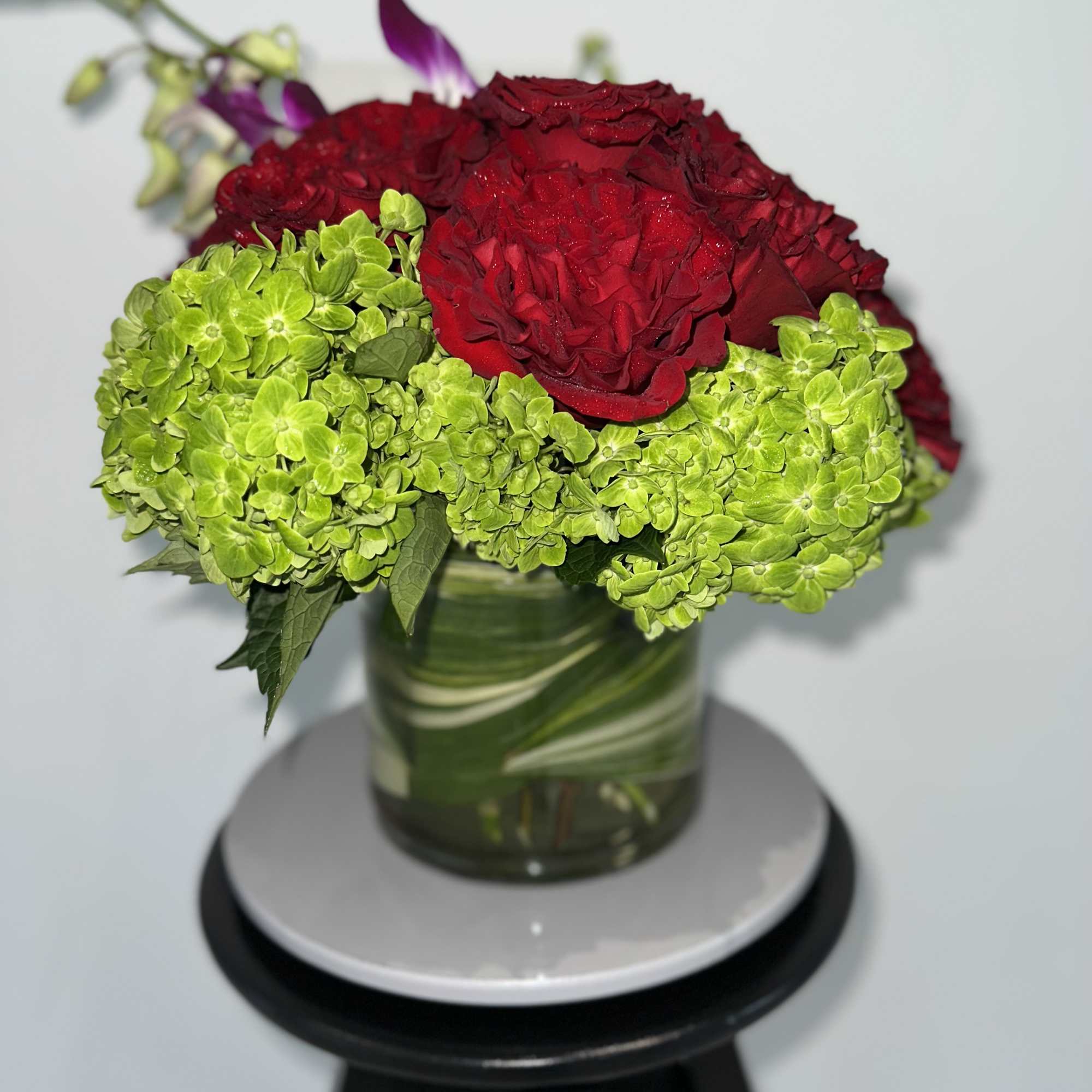 A celebration of luxury and life, this large and jewel toned arrangement