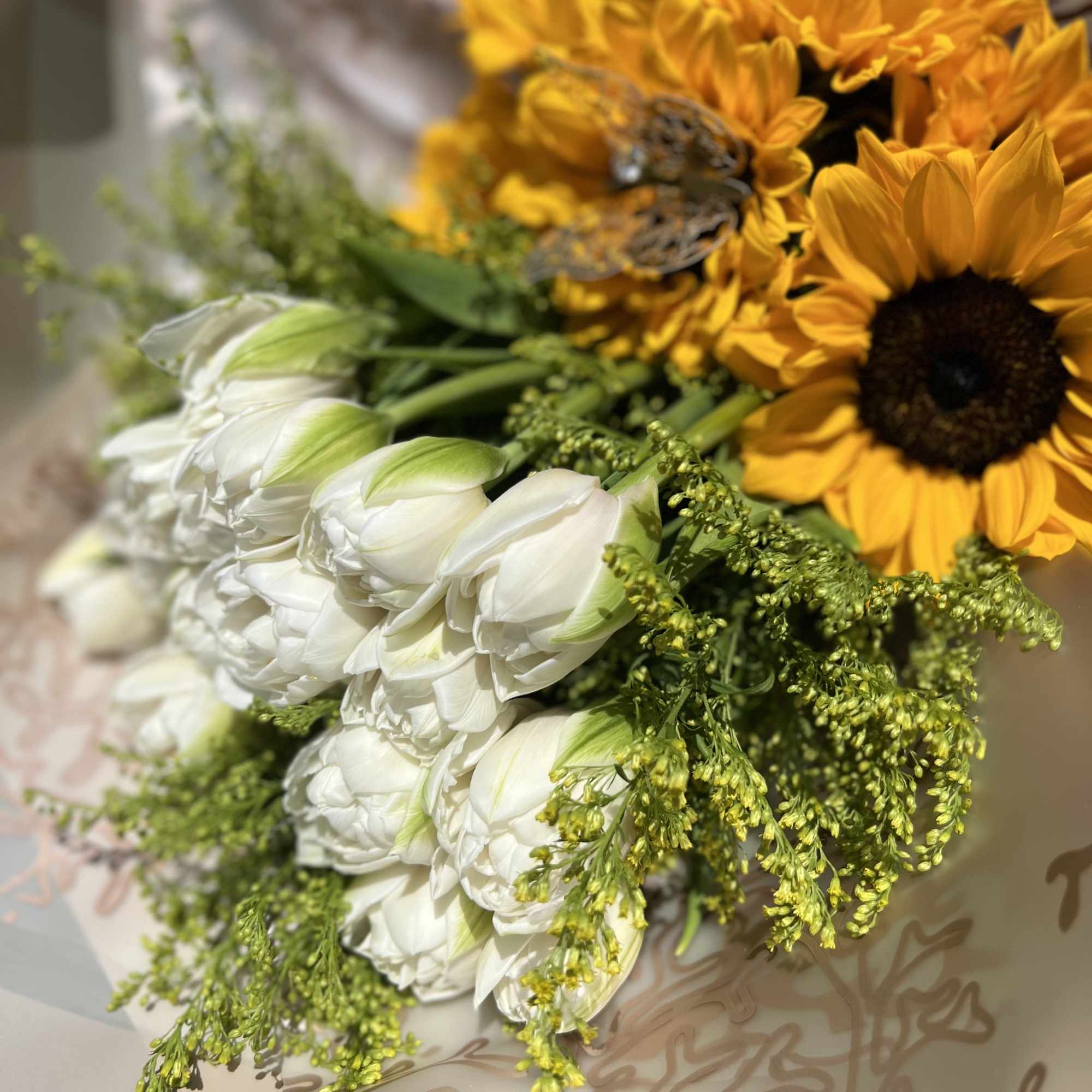 10 White Tulpis and 5 Sunflowers. Wrapped Champagne Paper.