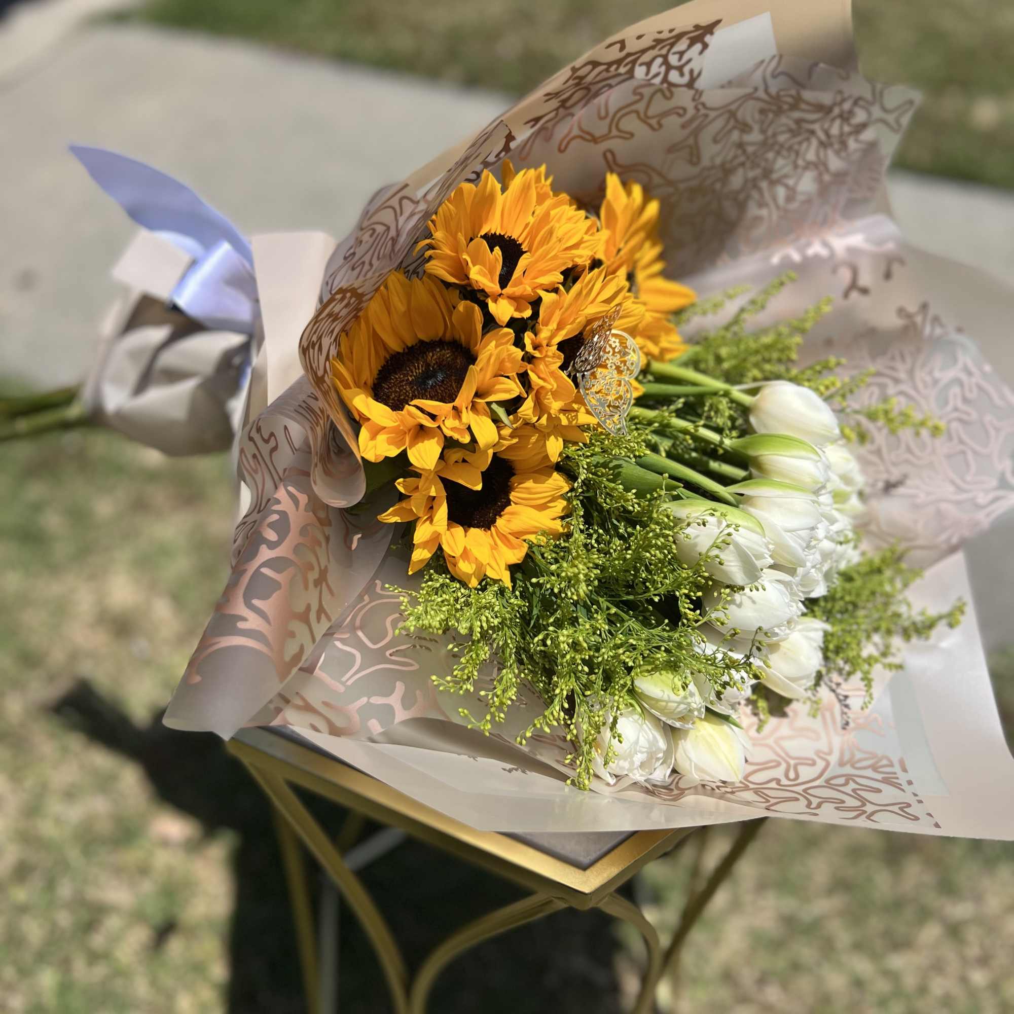10 White Tulpis and 5 Sunflowers. Wrapped Champagne Paper.