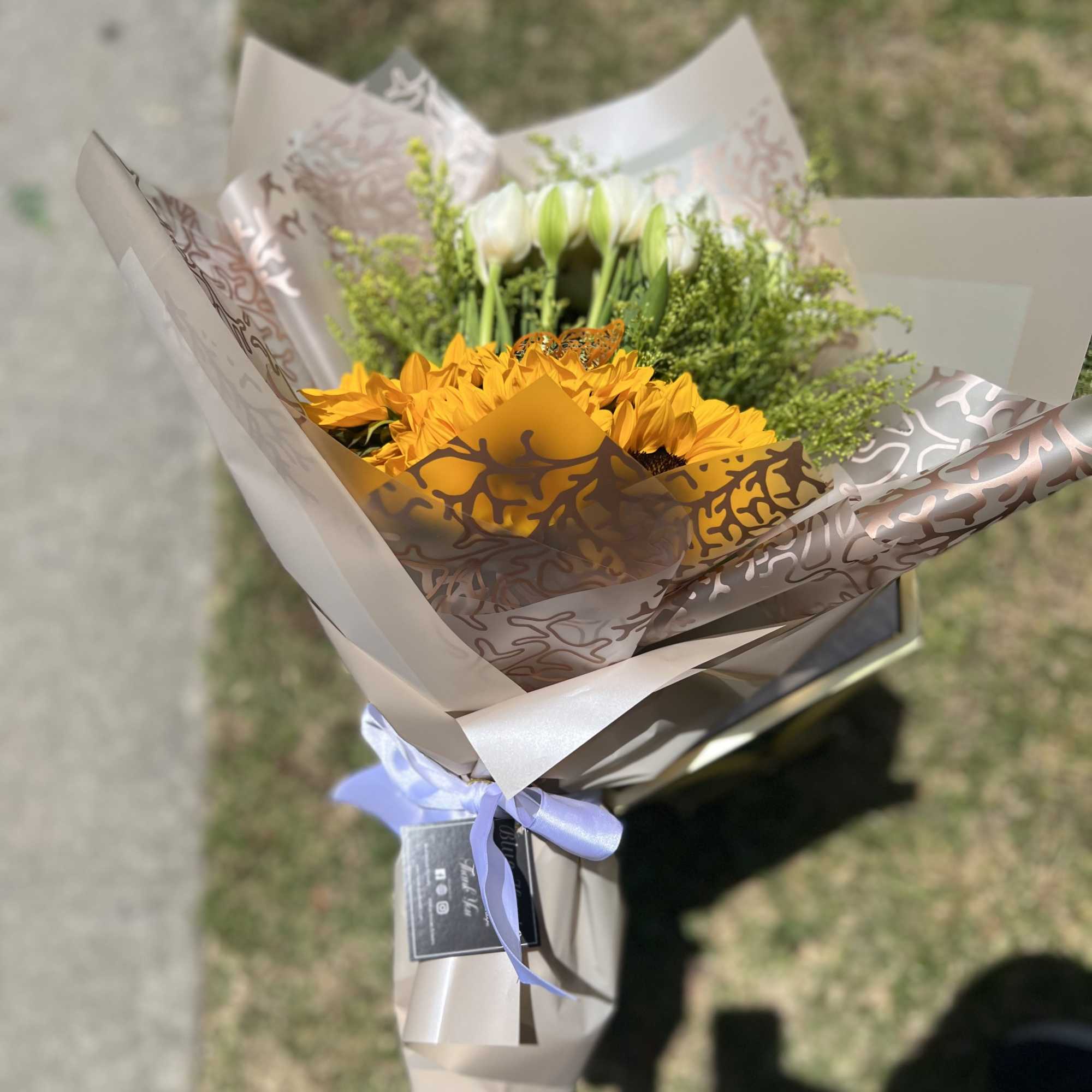 10 White Tulpis and 5 Sunflowers. Wrapped Champagne Paper.