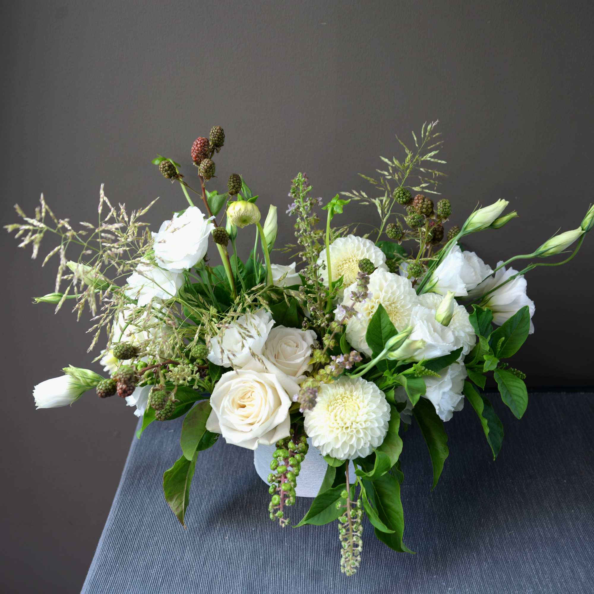 A seasonal variety of white blooms with accent greenery and texture. A seasonal variety of white blooms with accent greenery and texture.