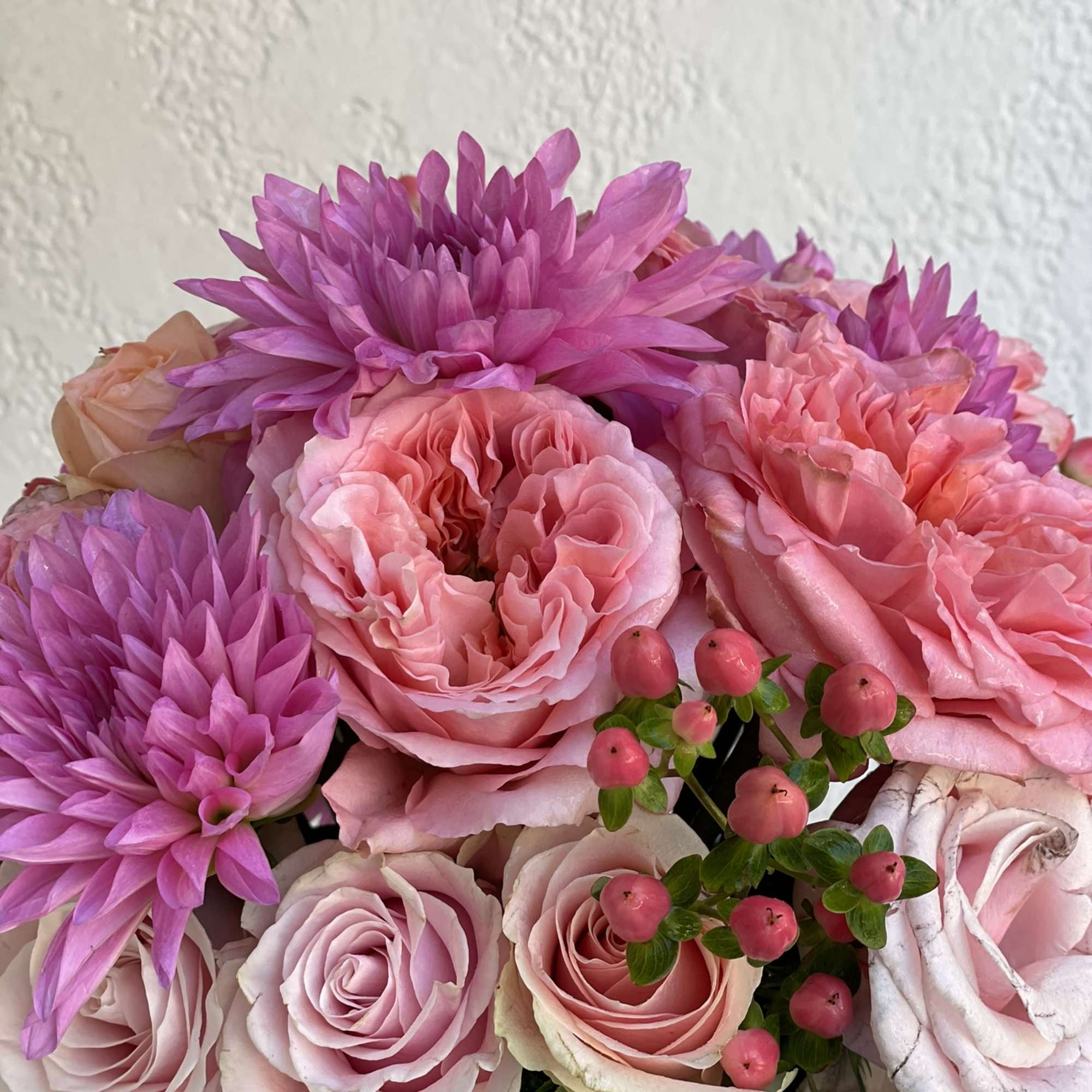 This stunning combination of roses and dahlias creates a compact, modern look