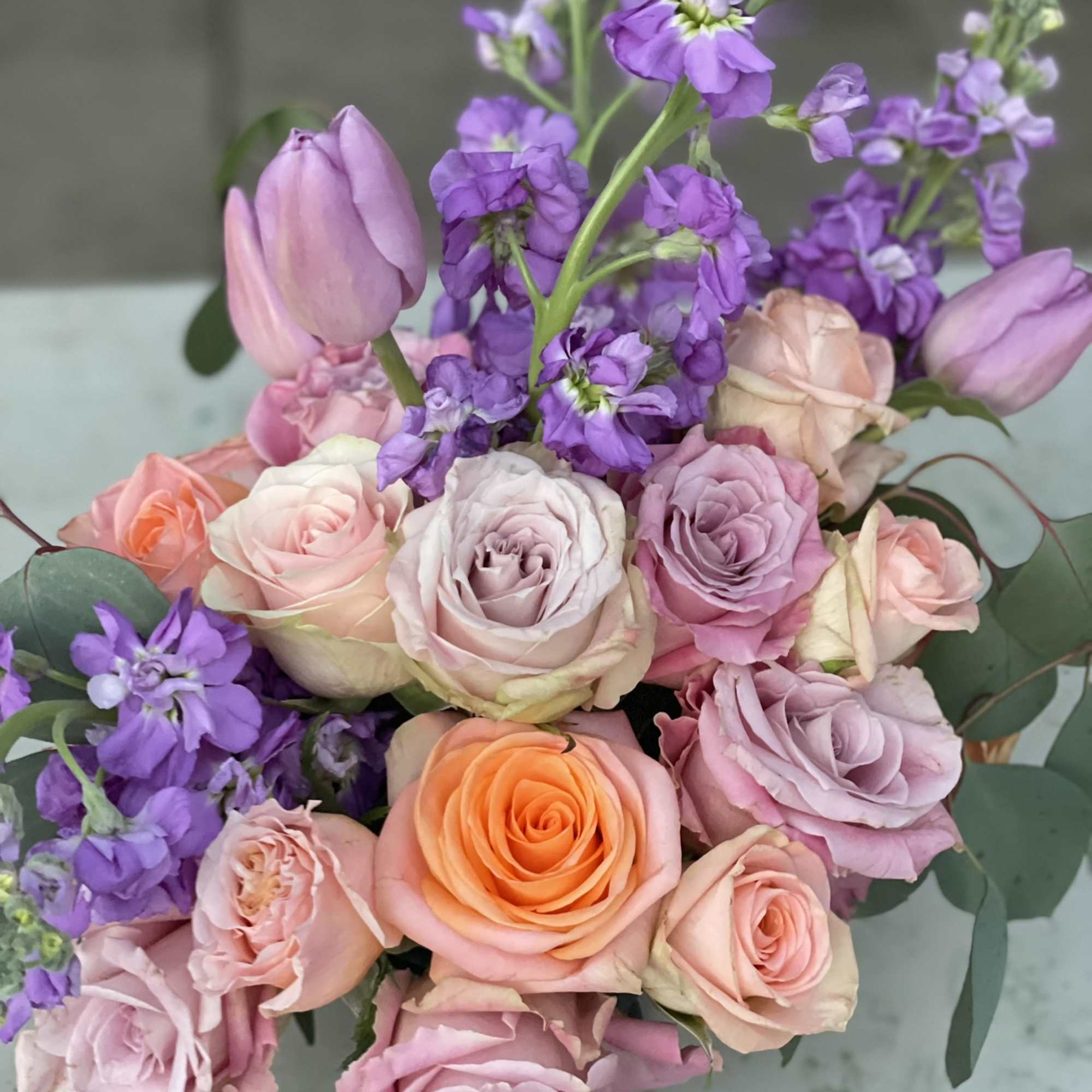 This combination of pastel roses, tulips and stock radiate happiness. The soft