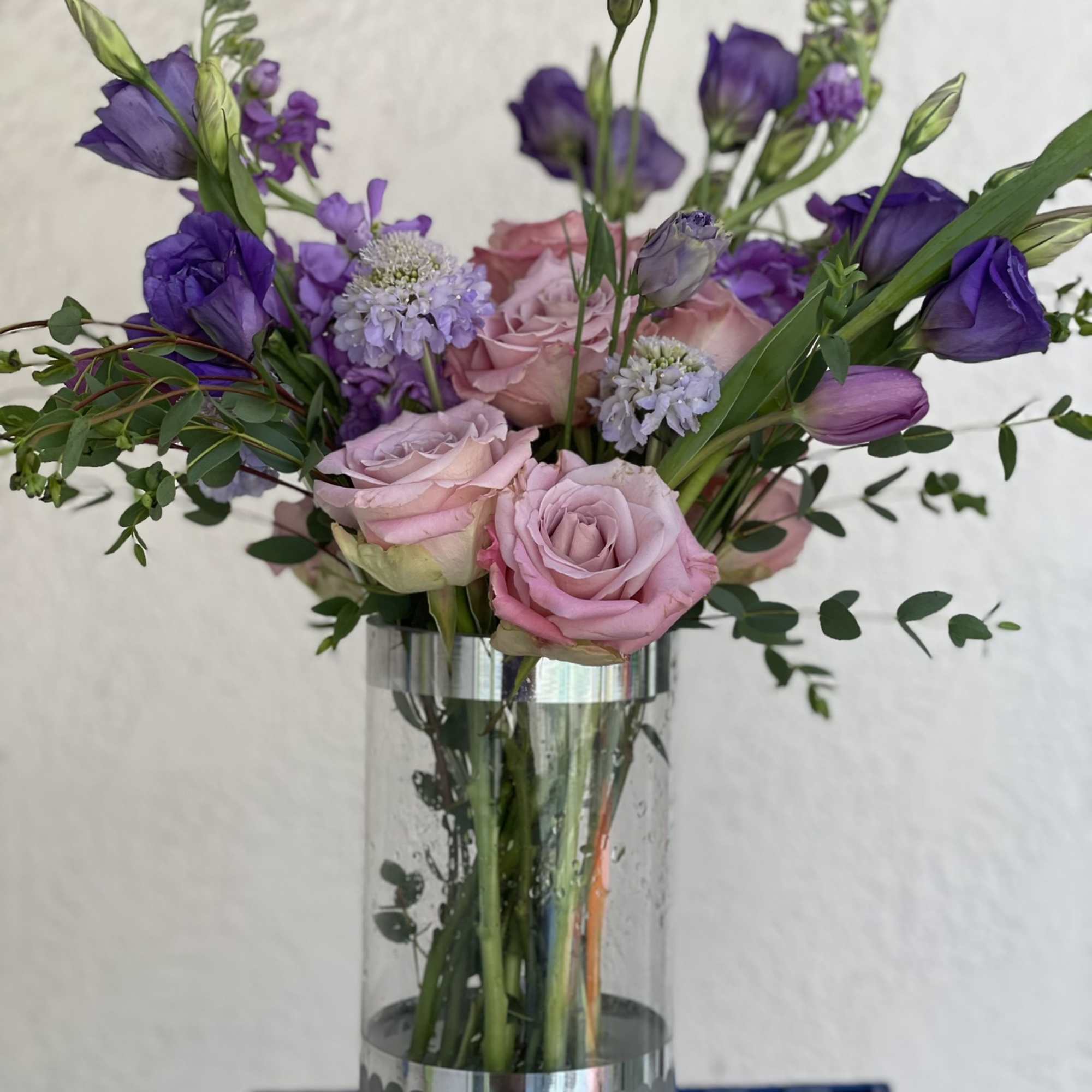 This arrangement boasts a striking spectrum of purple, from lavender to deep