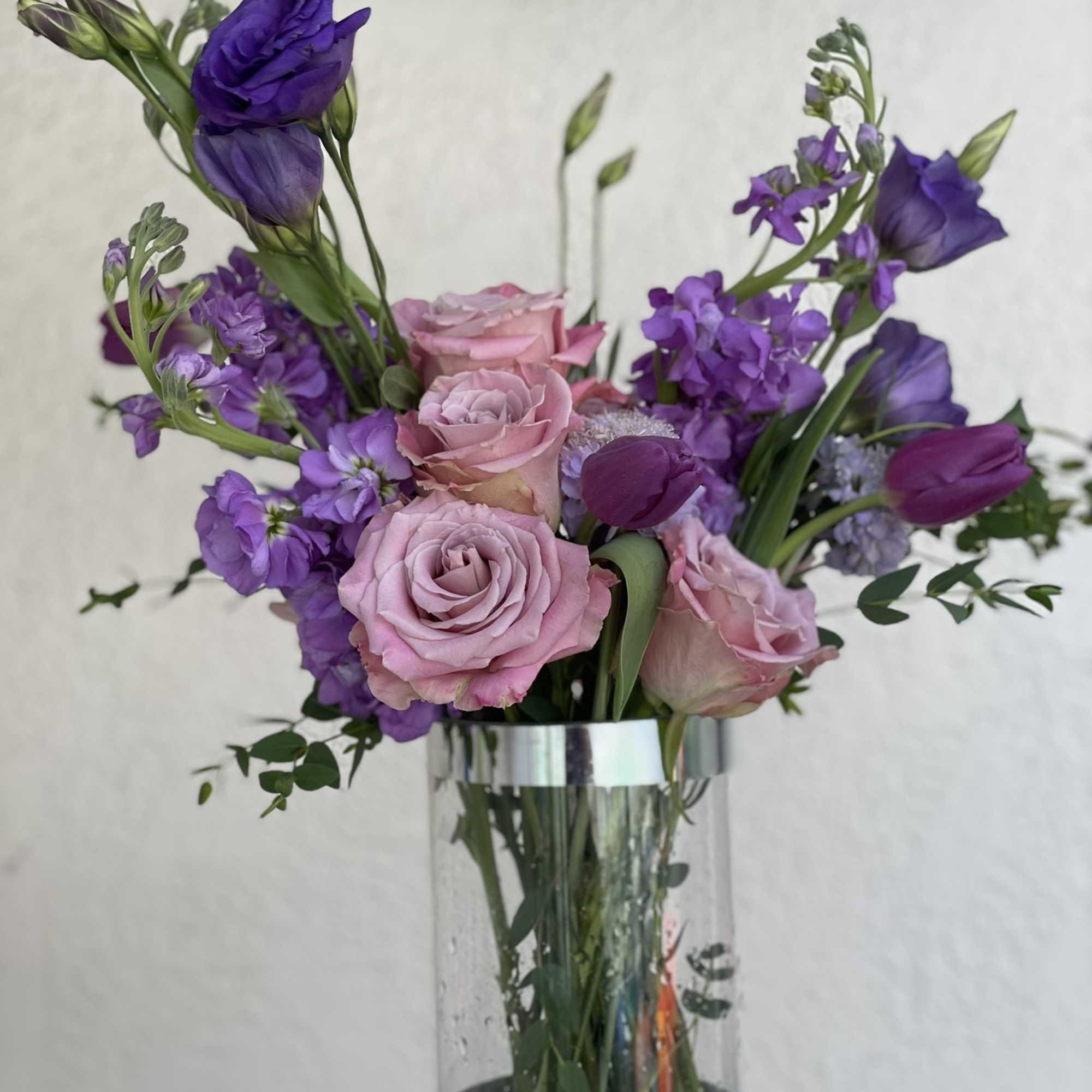 This arrangement boasts a striking spectrum of purple, from lavender to deep