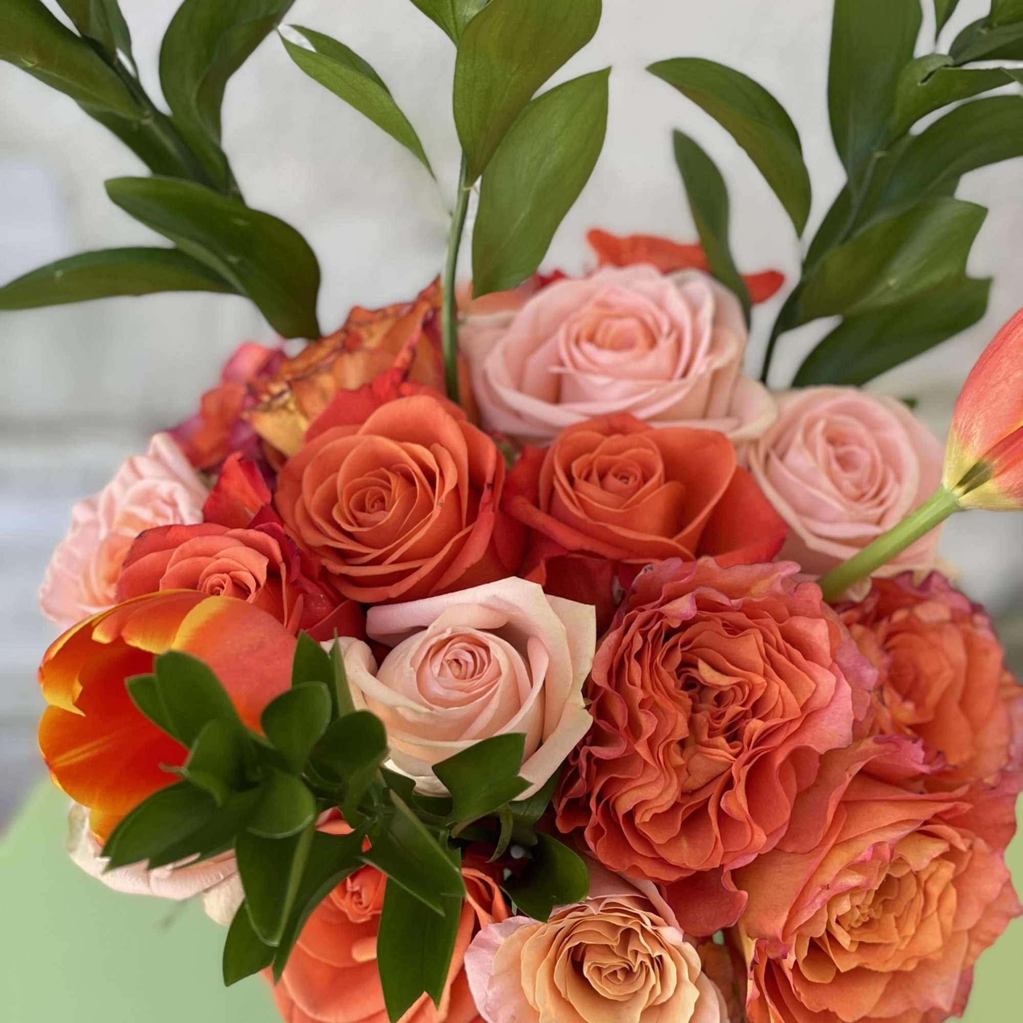 This arrangement is a beautiful combination of garden roses,tulips, and roses in