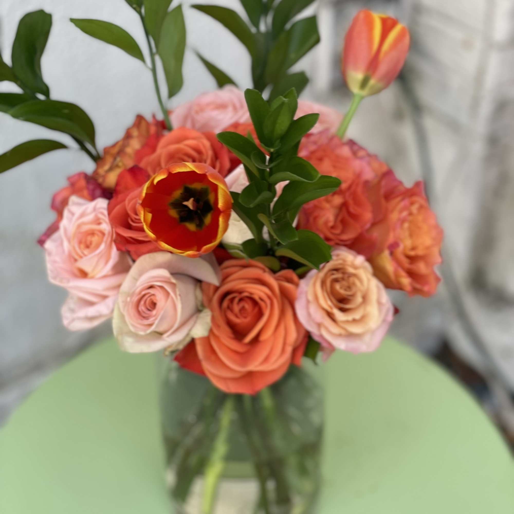 This arrangement is a beautiful combination of garden roses,tulips, and roses in