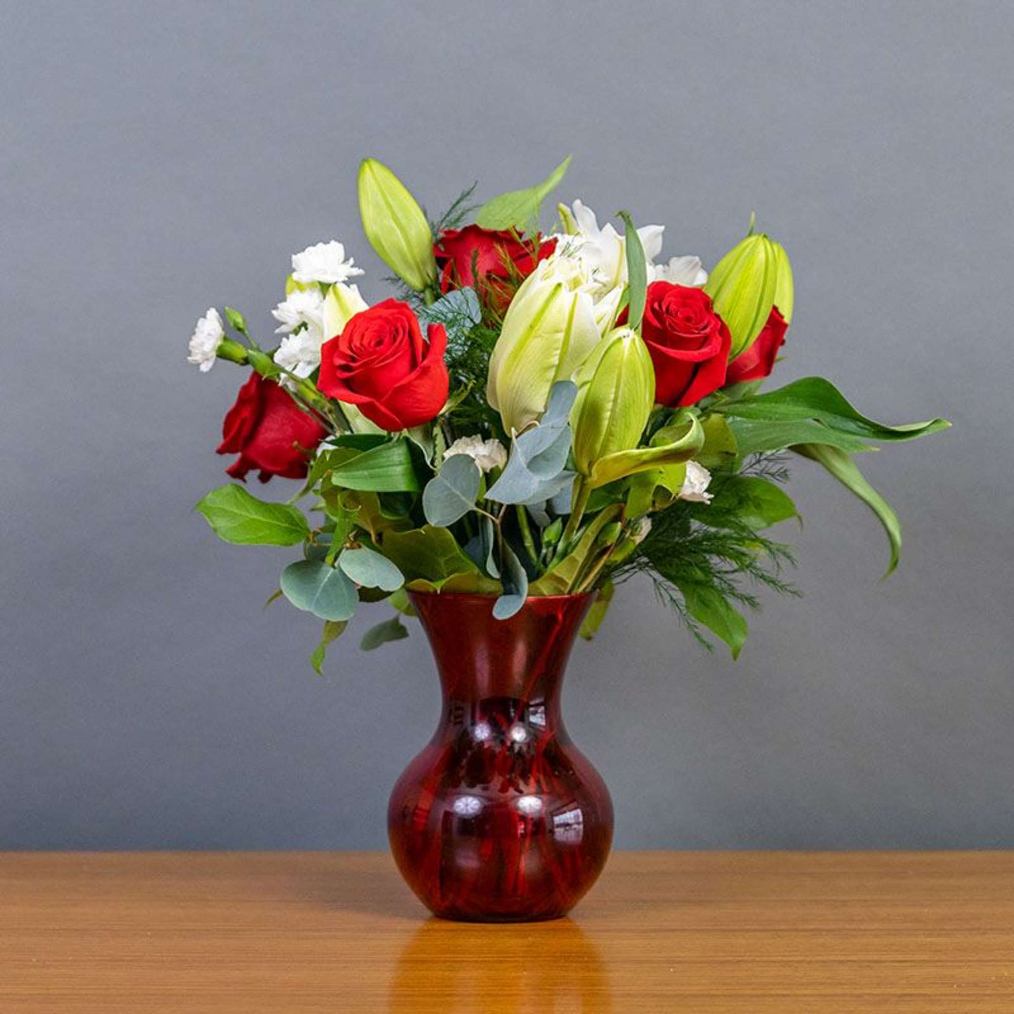 Lilies, Red Roses, Alstroemeria and White Hydrangea ready to say you care.