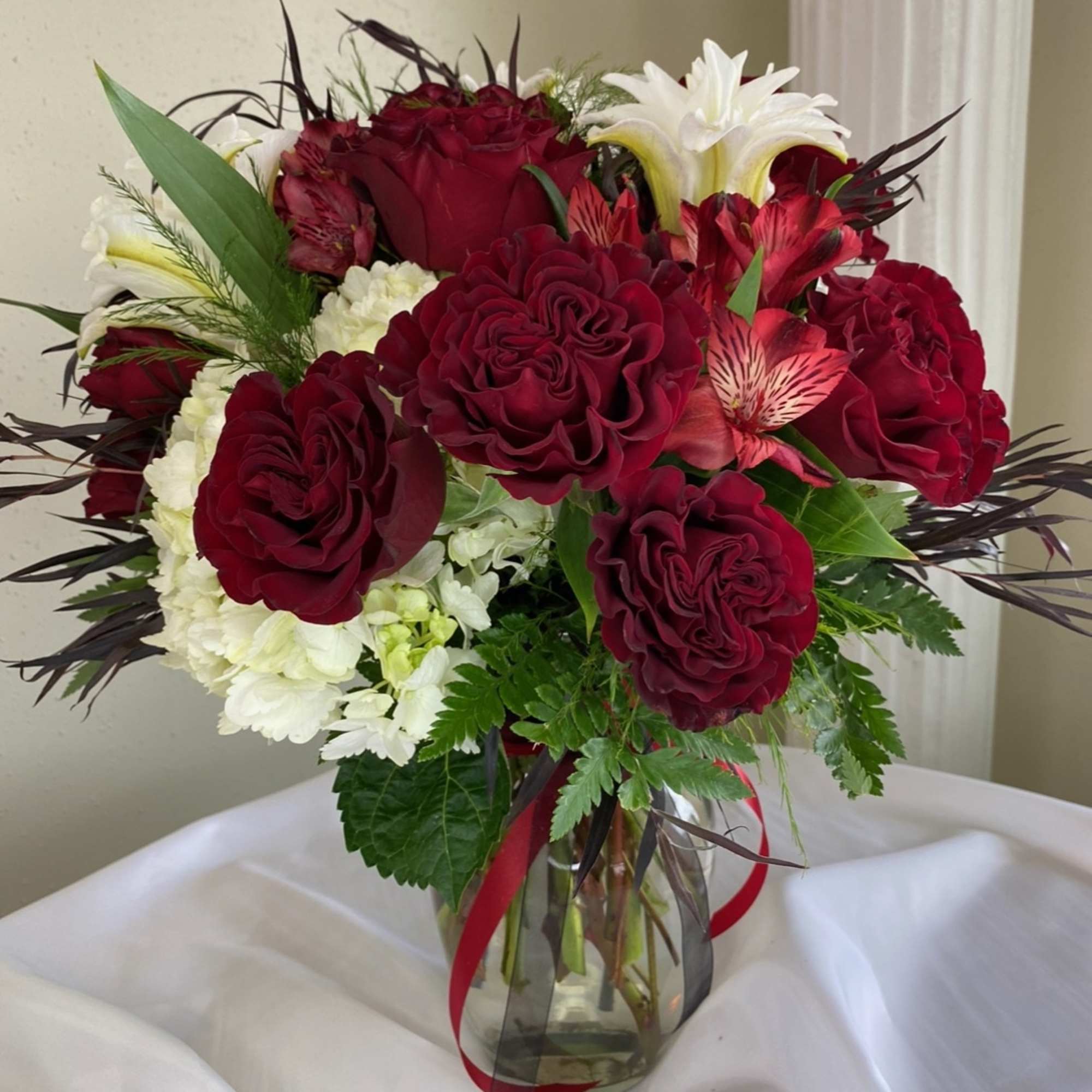 Lilies, Red Roses, Alstroemeria and White Hydrangea ready to say you care.