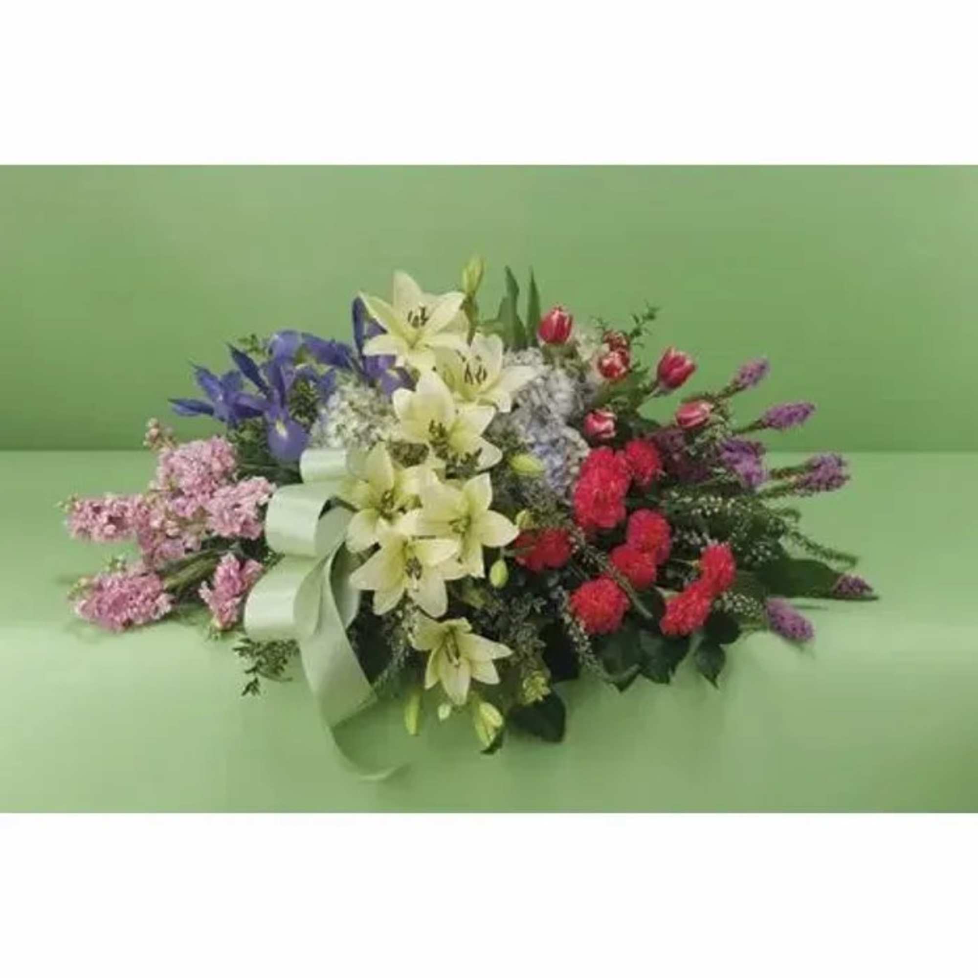 A grouped design with lilies, stock, iris, carnations and tulips. Seasonally, types