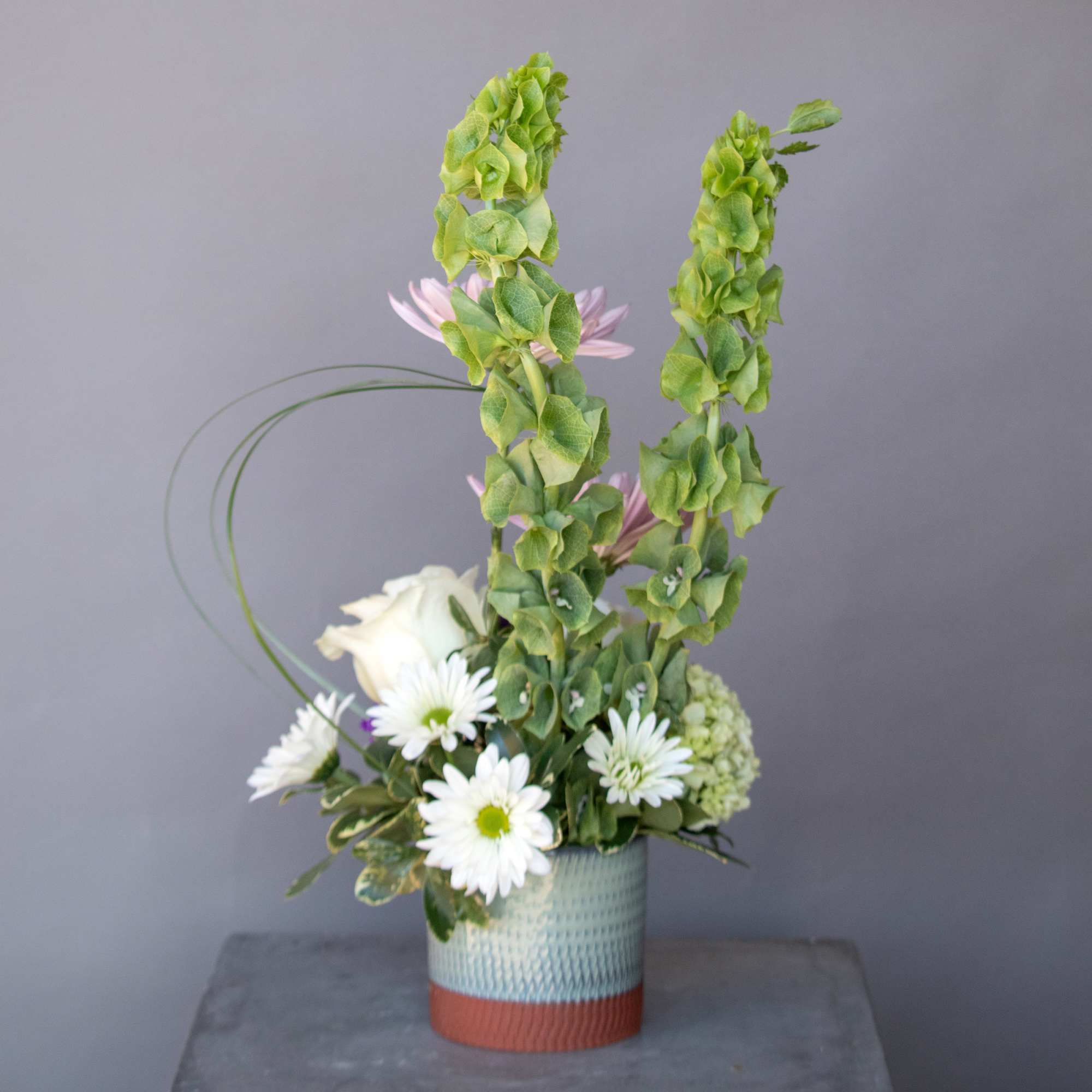 Embrace the elegance of spring with &quot;Pearls &amp; Amethyst,&quot; a breathtaking arrangement