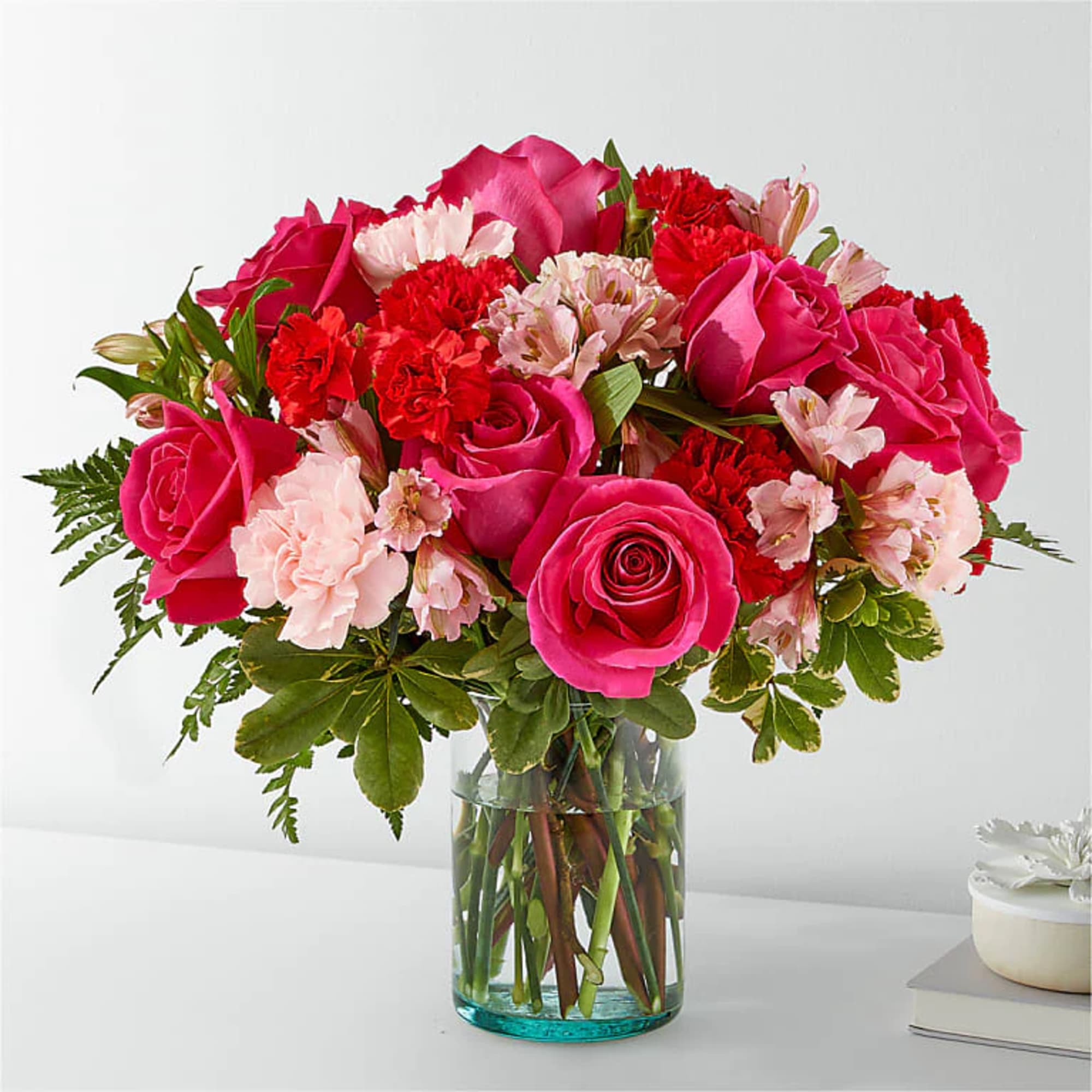 Blushing shades of pink blooms like roses, alstroemeria and carnations to name