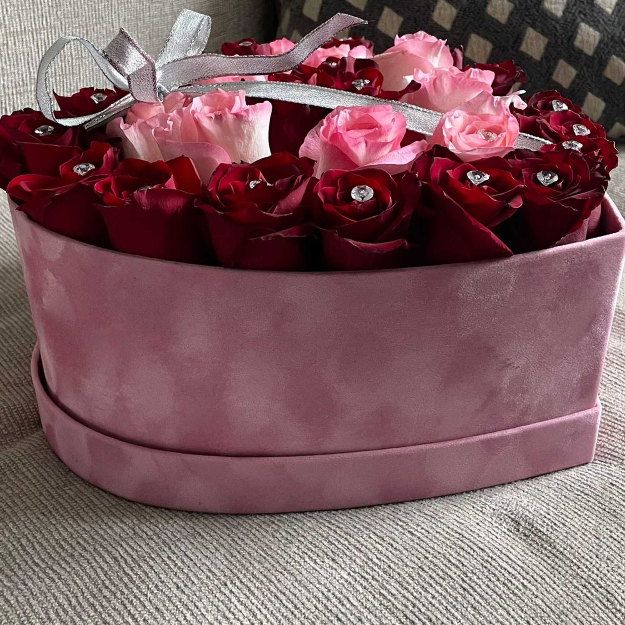 Romantic roses in a heart shaped velvet box. 