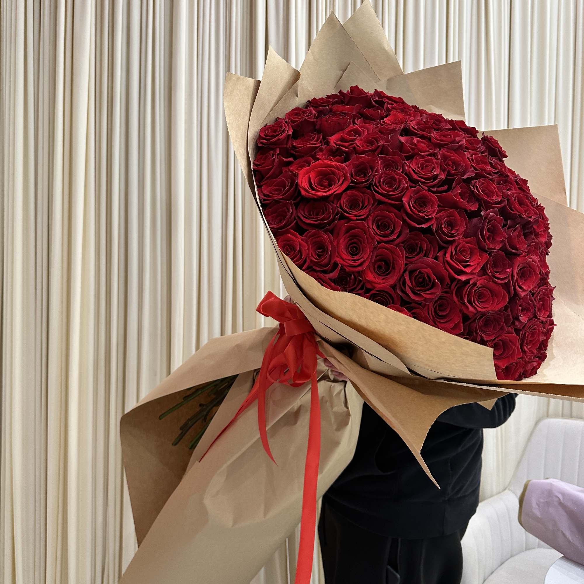 Wrapped in a cascading dress style, this dramatic bouquet of 150 
