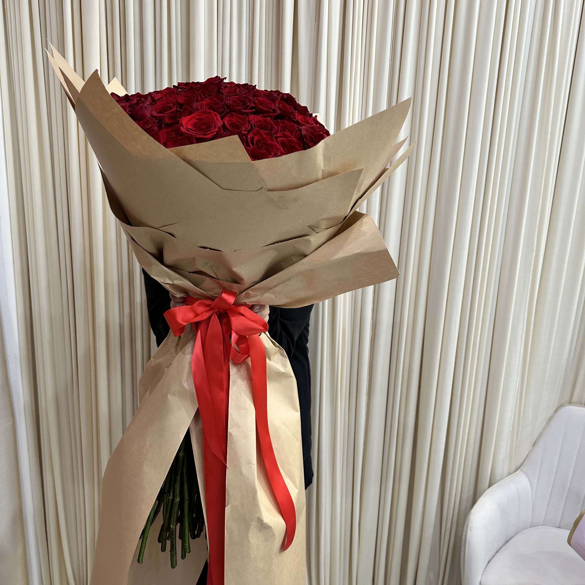 Wrapped in a cascading dress style, this dramatic bouquet of 150 