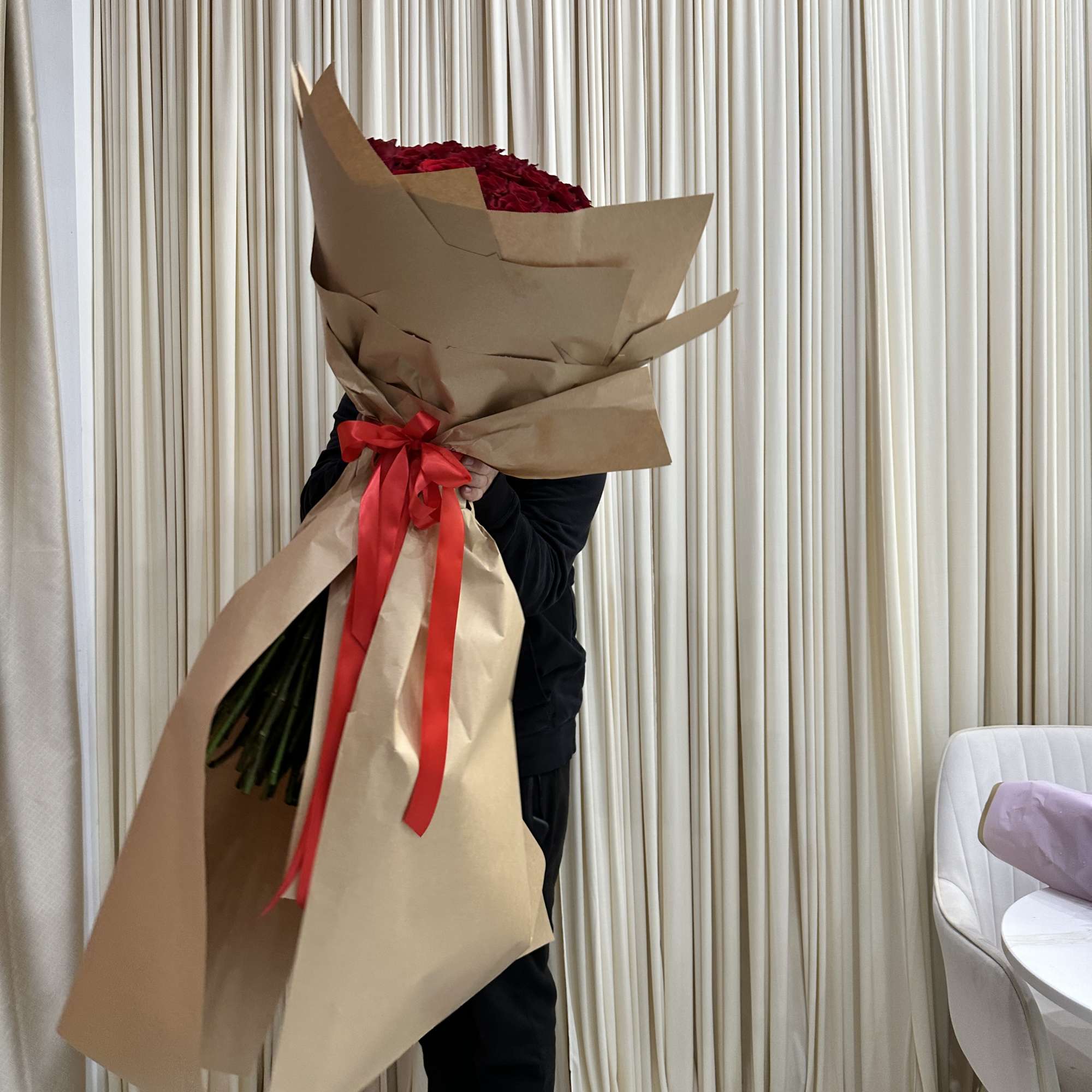 Wrapped in a cascading dress style, this dramatic bouquet of 150 