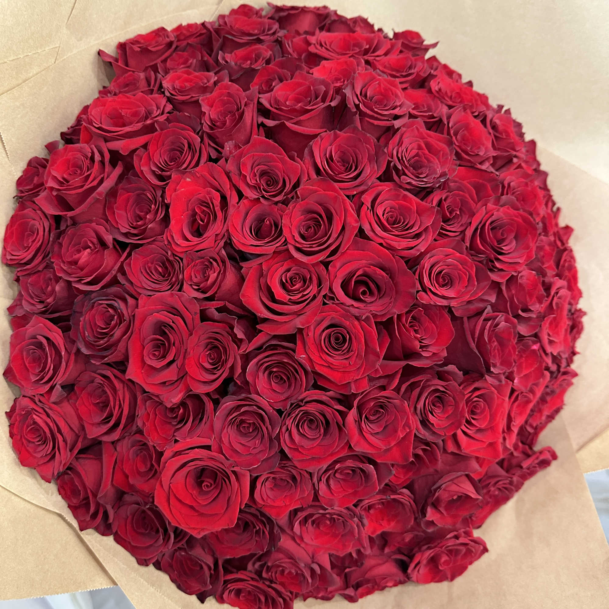 Wrapped in a cascading dress style, this dramatic bouquet of 150 