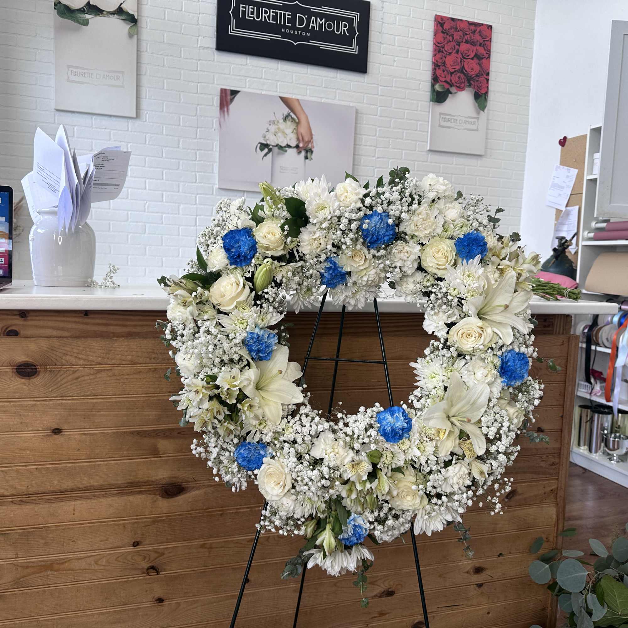 Introducing "Azure Remembrance Heart," a touching floral arrangement featuring blue roses, designed Introducing "Azure Remembrance Heart," a touching floral arrangement featuring blue roses, designed