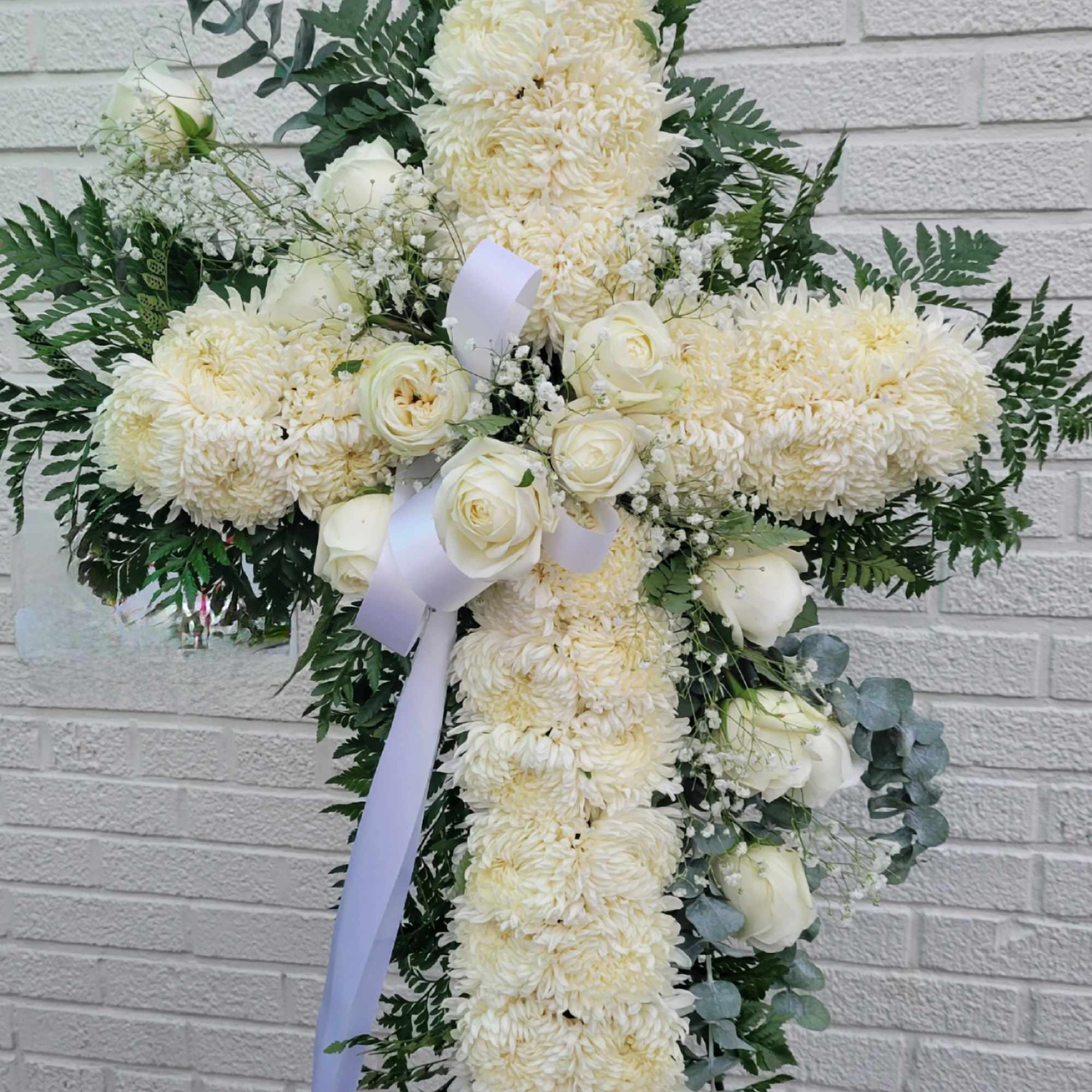 it is made with:
30 white mums
12 white roses
2 baby breath
greens 
eucalyptus
white bow
