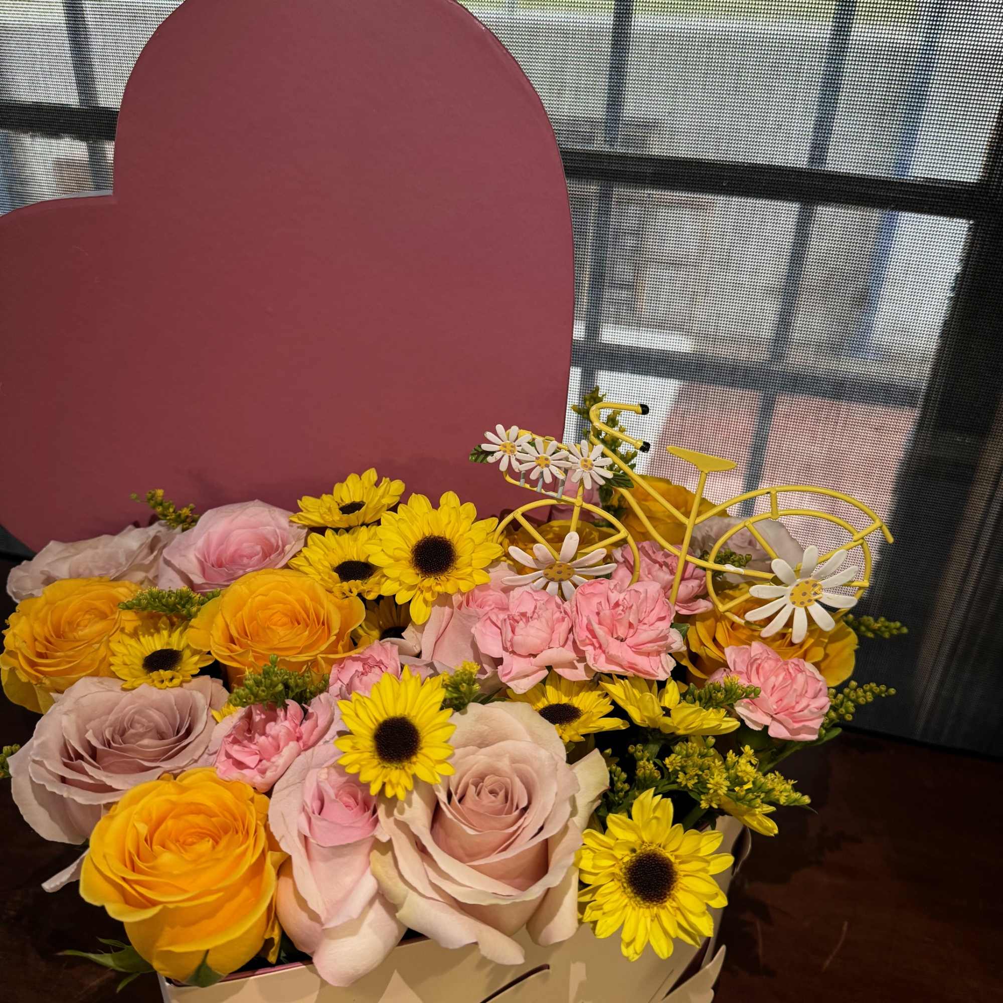 Spring color flowers inside a heart box 