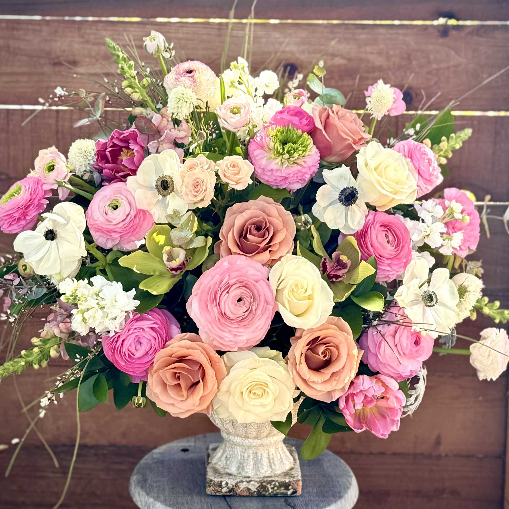 A lovely display of seasonal pink, white and green flowers named after