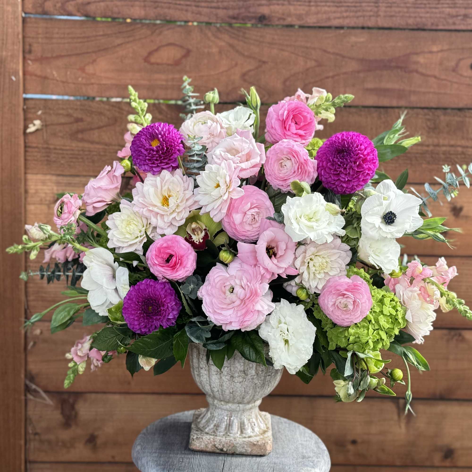 A lovely display of seasonal pink, white and green flowers named after