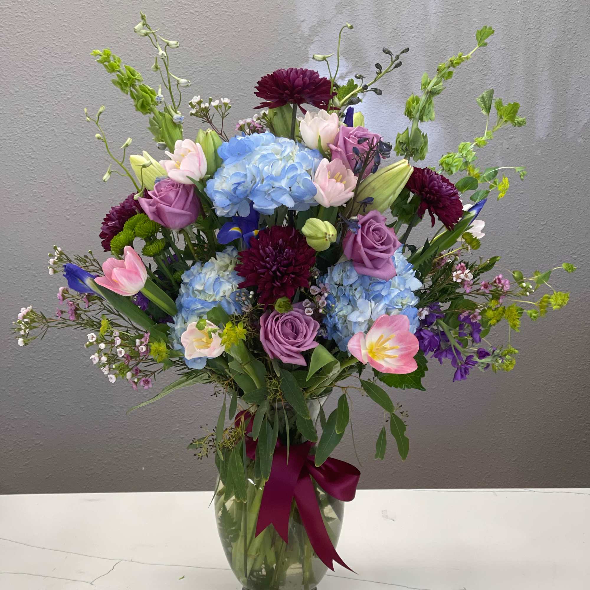 The beaut is dripping in jewel toned blooms ready to bring a