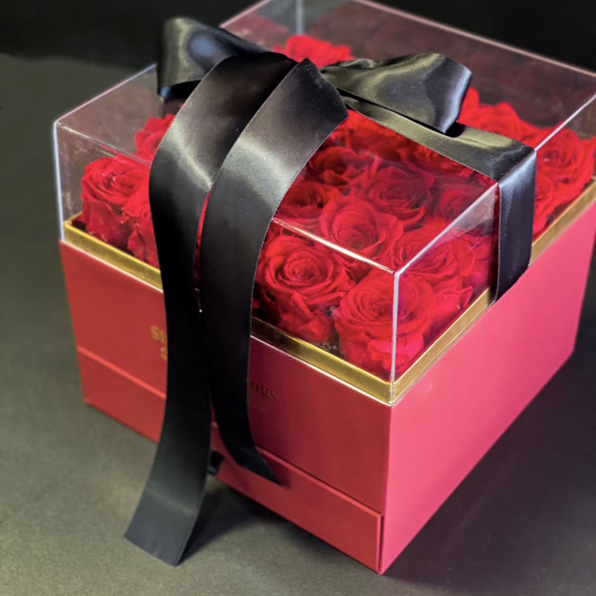 Red Forever Roses in acrylic box 
This elegant arrangement of Preserved Luxury