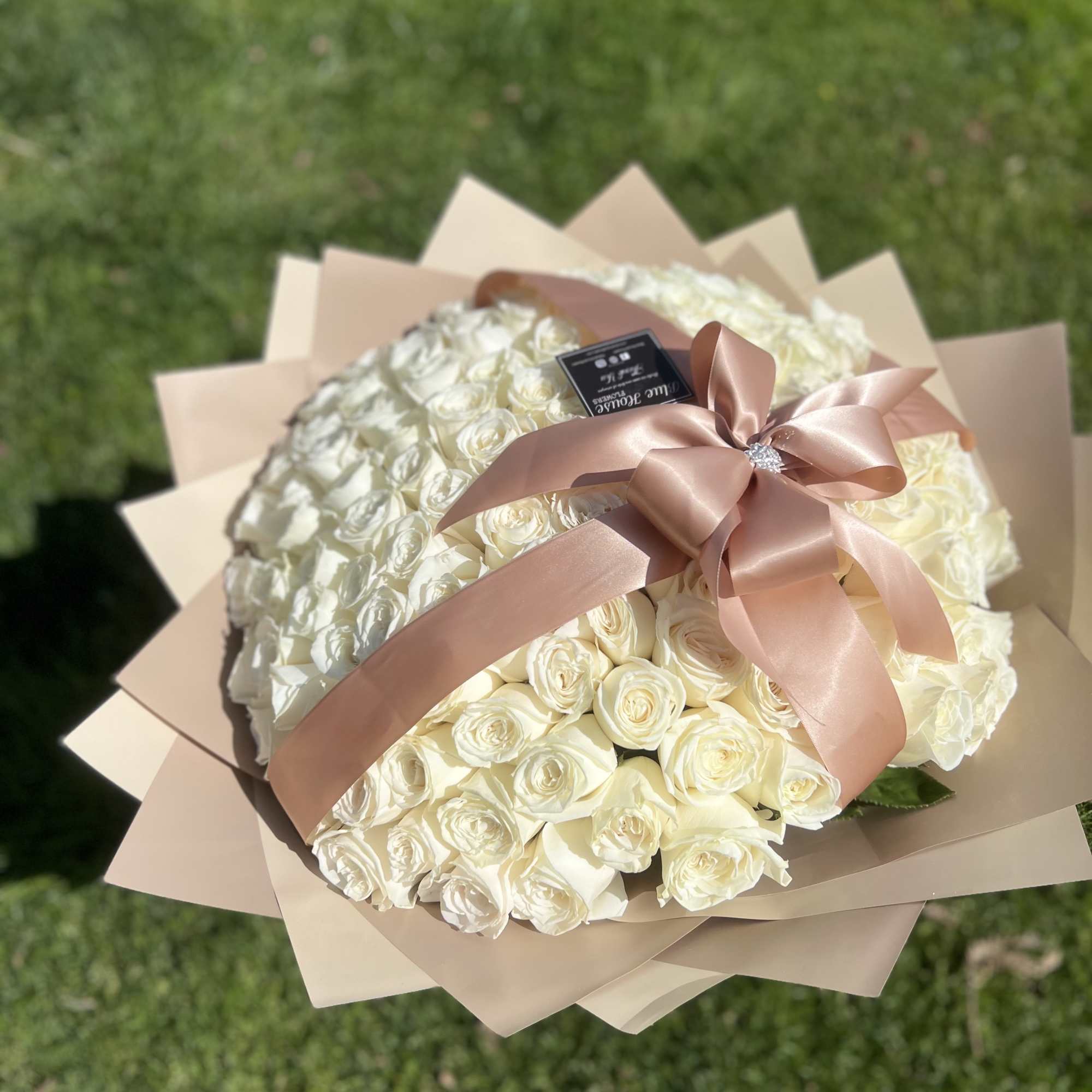 100 Long White Roses Wrapped Champagne.