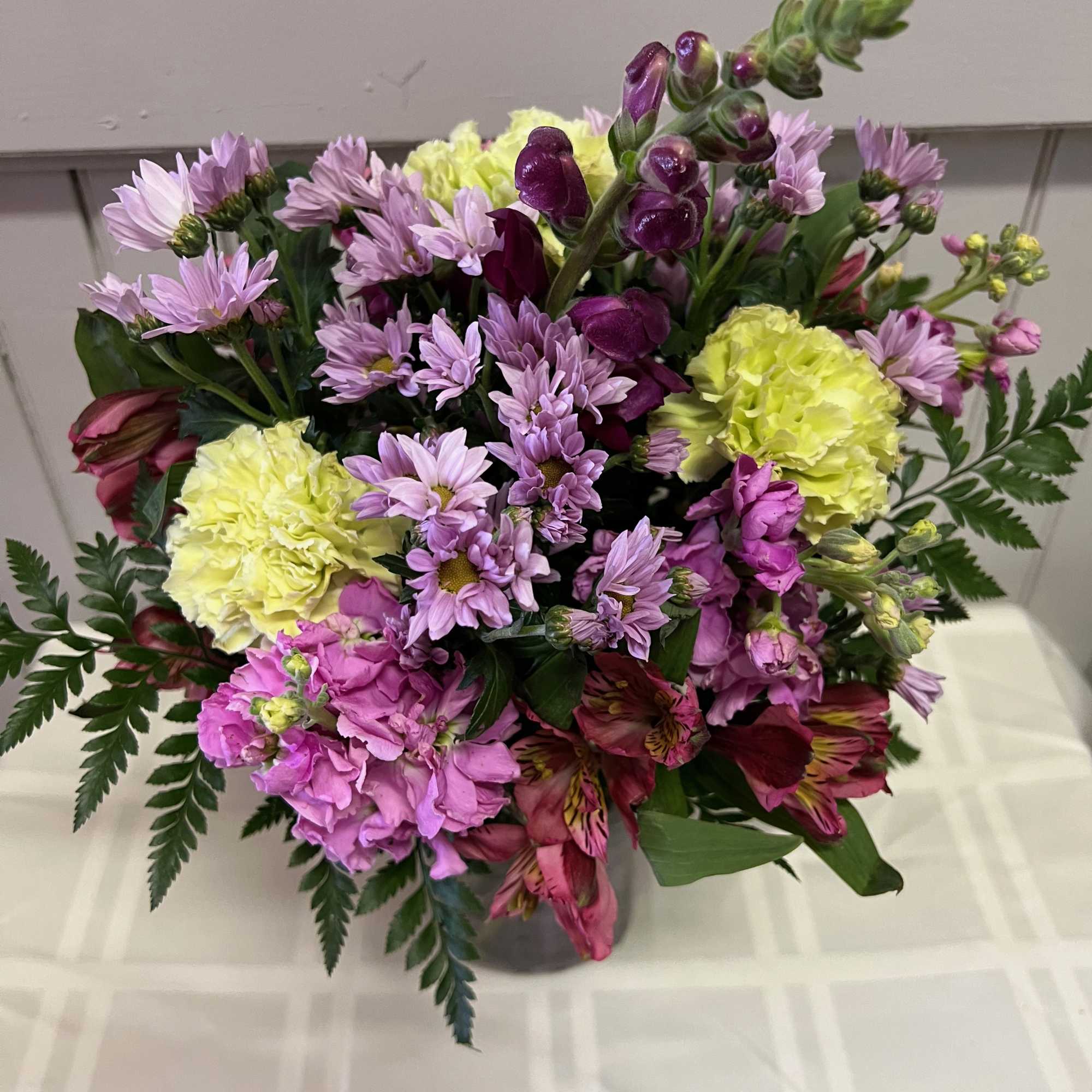 An array of purple flowers with a hint of green arranged in