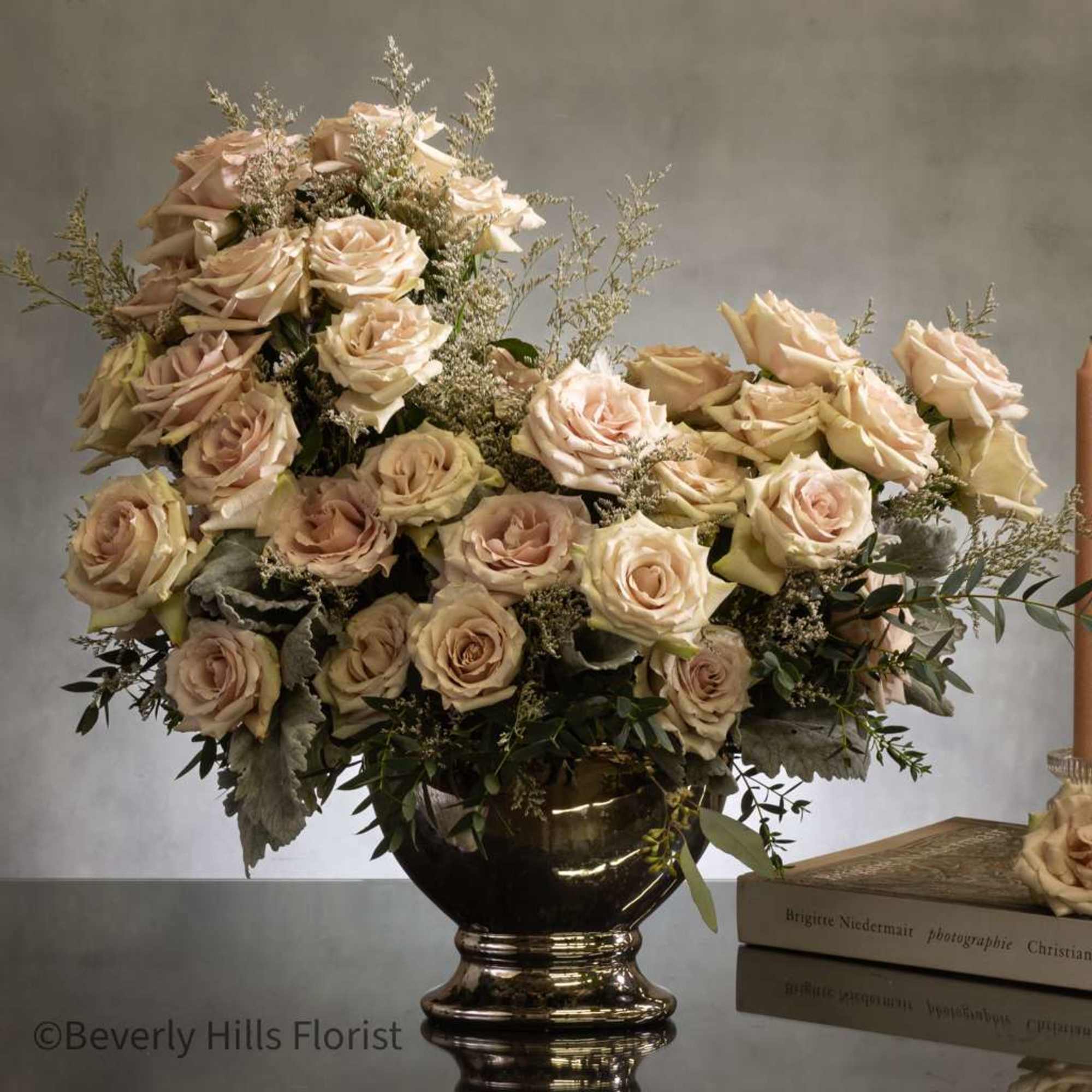 Experience sophistication with a breathtaking arrangement of fifty opulent sand-colored roses in