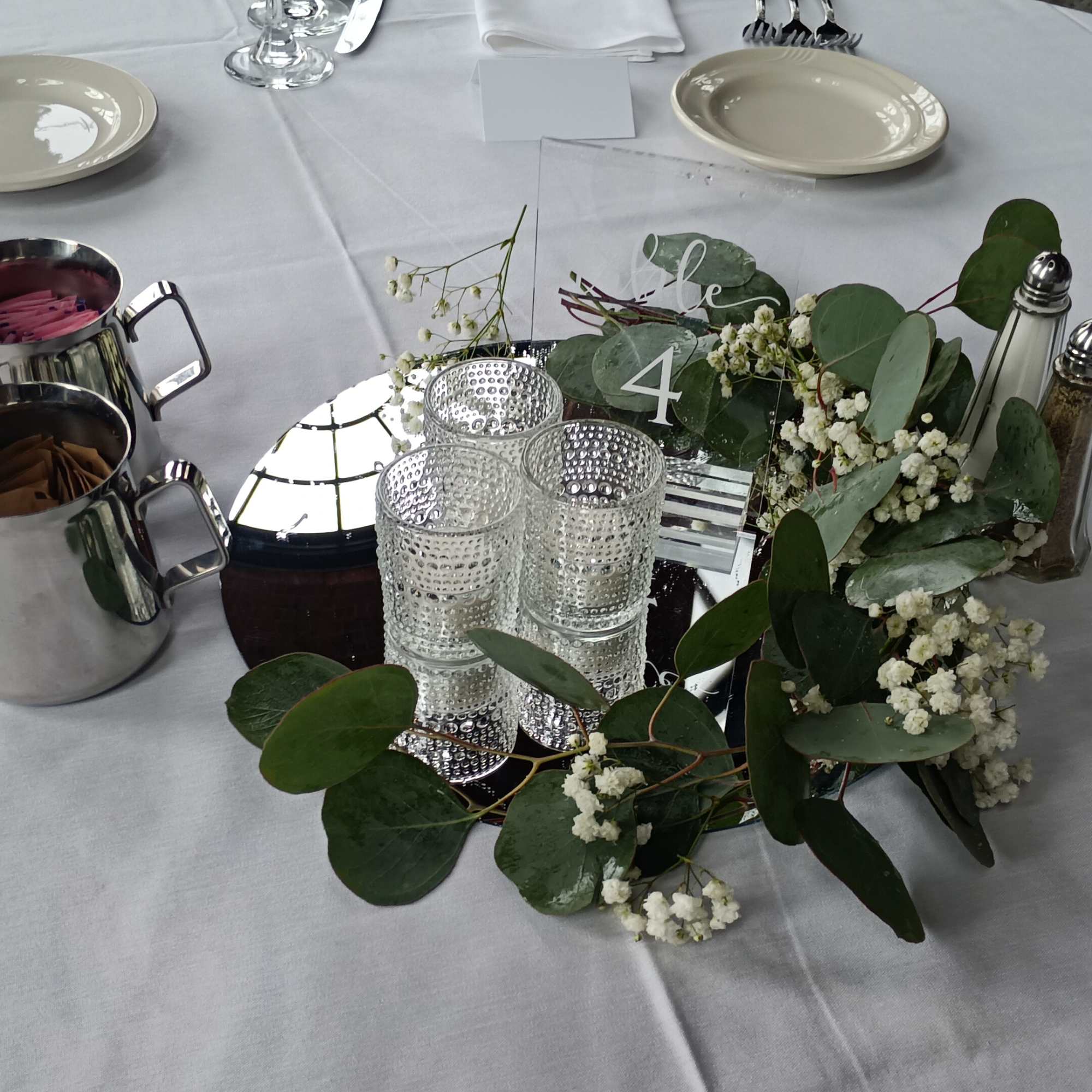 Beautiful fresh &quot;Silver Dollar&quot; eucalyptus &amp; baby&#039;s breath writhe around candleholders centerpiece